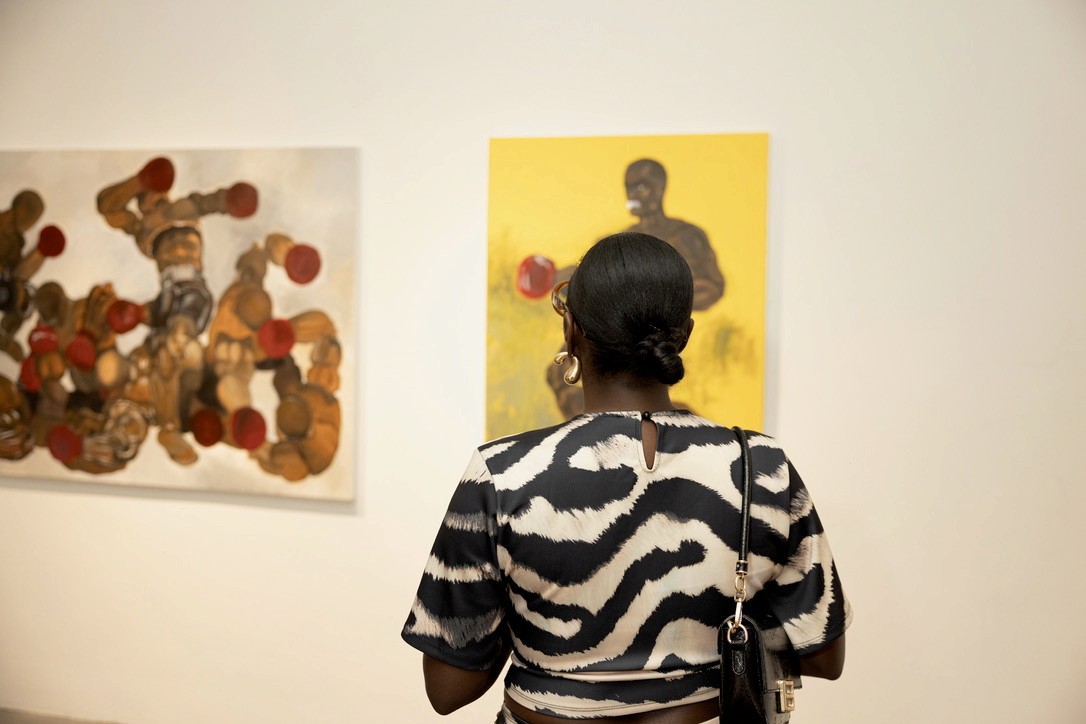 Visitor looking at paintings in Soft Armor