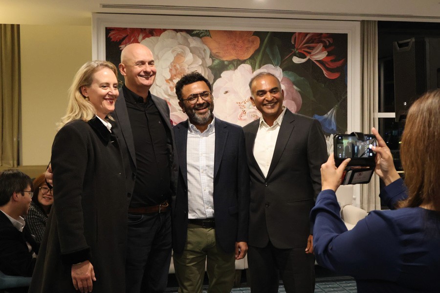 four people pose for a photo