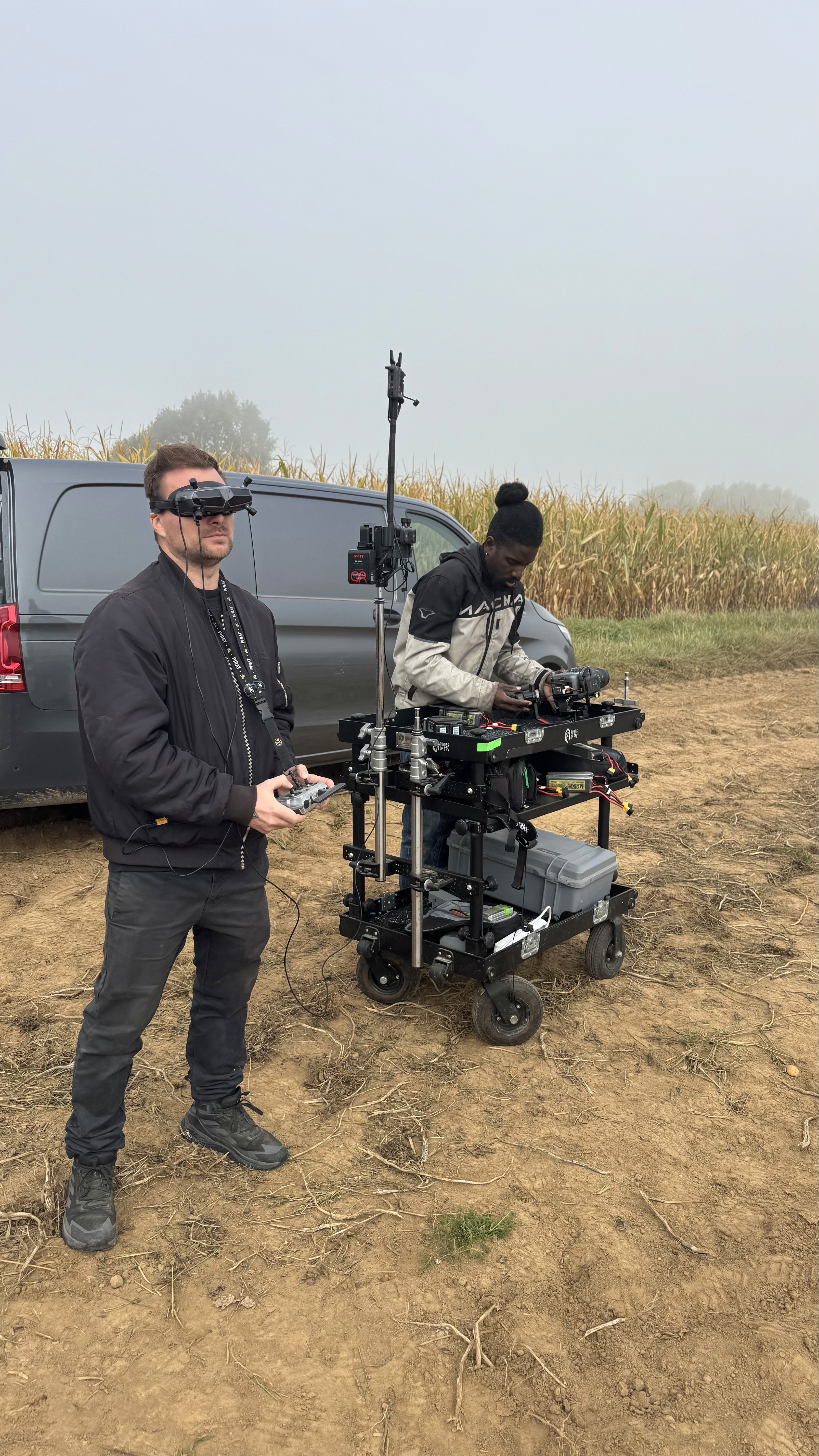 Black and white image of people working at a table with laptops, showing hands gesturing during discussion of digital content displayed on screens, with fabrica® logo in the corner.