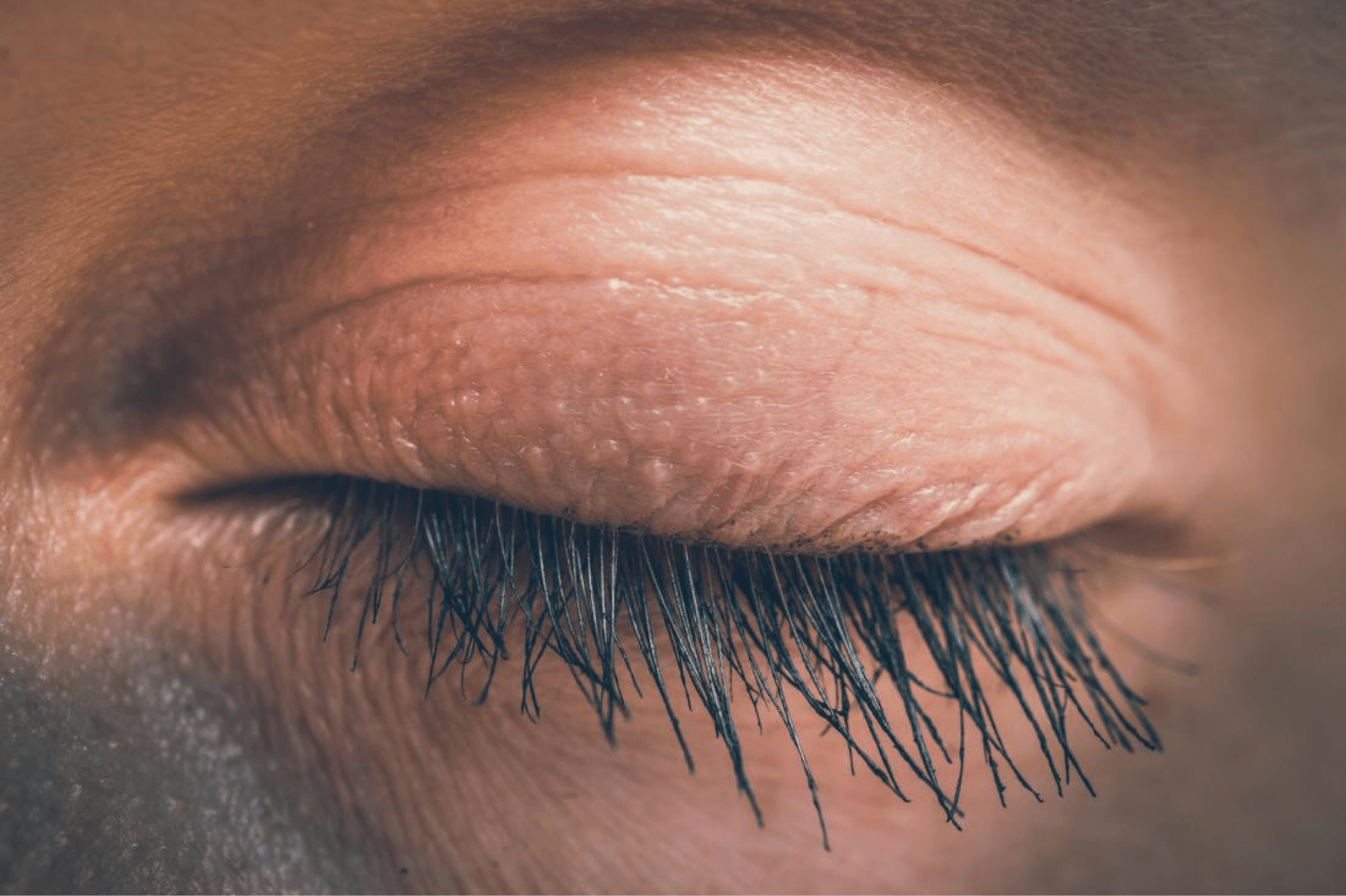 Close-up of a closed human eyelid, representing relaxation and eye care.