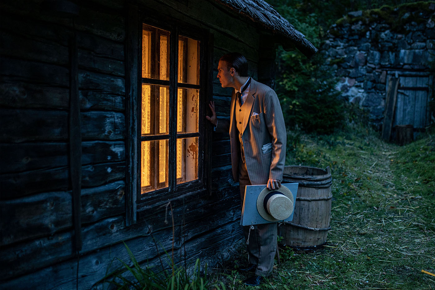 Scene from The Bog, where main hero Toomas Haava secretly looks through a window. A WW1-era Estonian love drama about passion, danger, and destiny based on Oskar Luts’ classic novel.