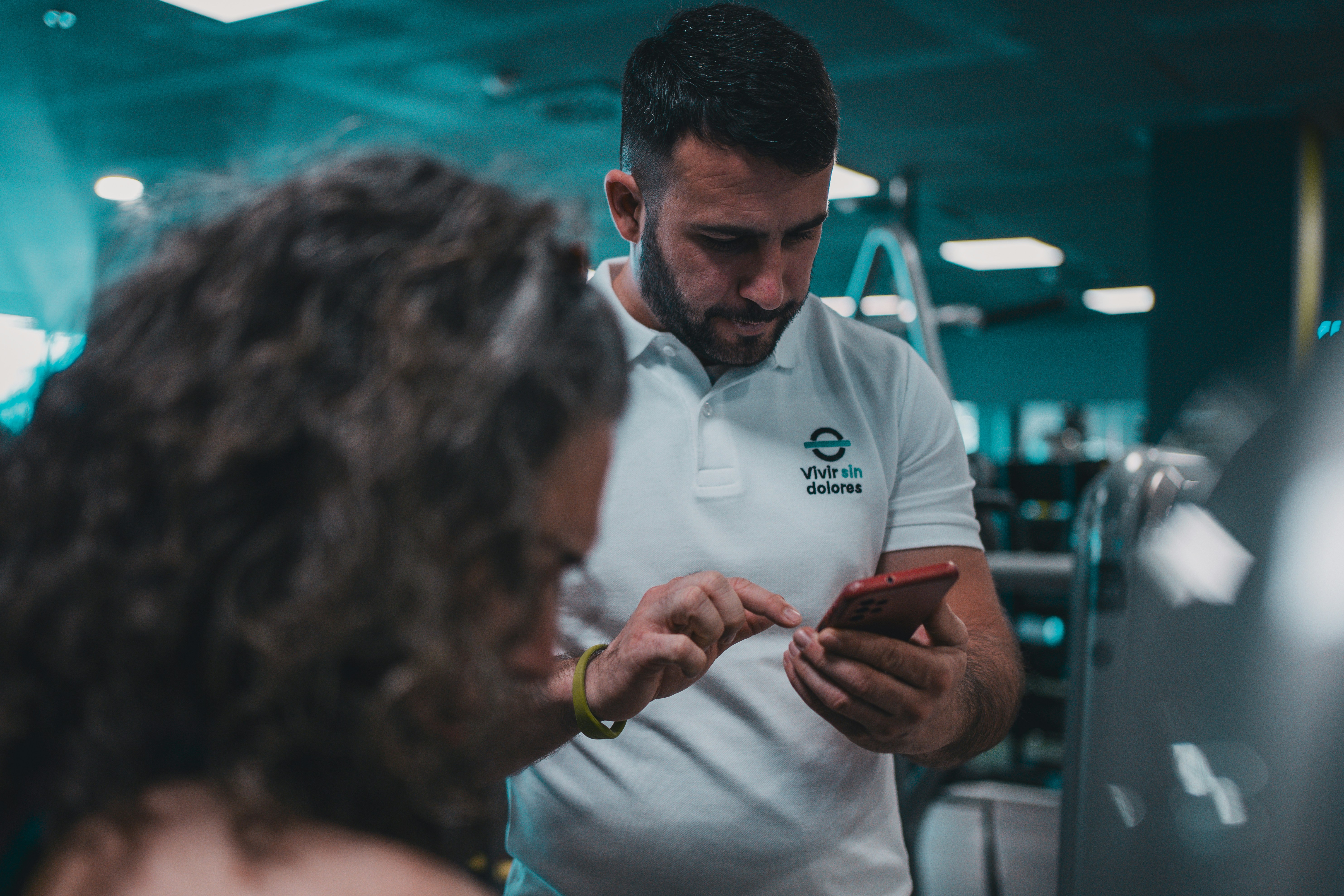 A man and a woman looking at a cell phone