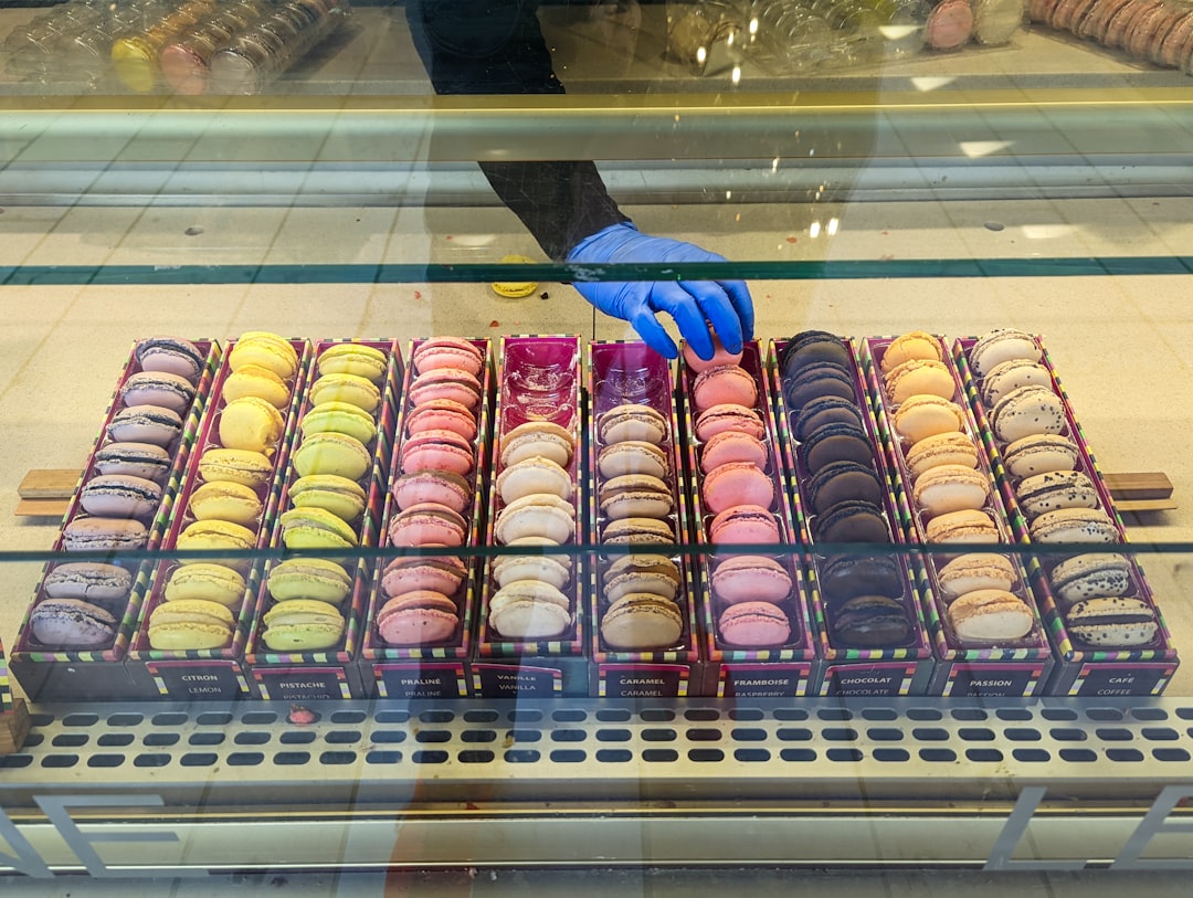 a display case filled with lots of different colored donuts