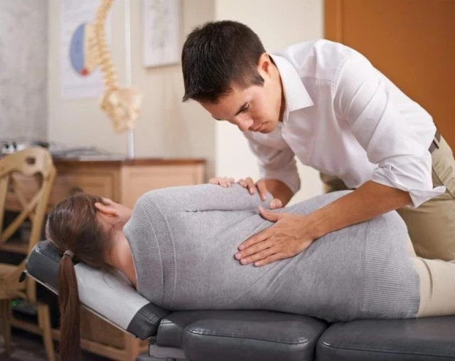 Physiotherapist checking for pain 