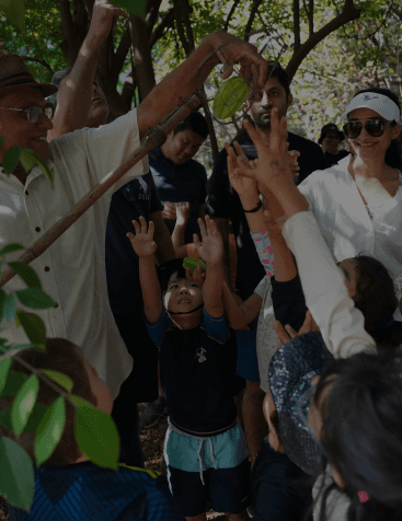 A family spending time in outdoors with kids to help them understand importance of outdoors.