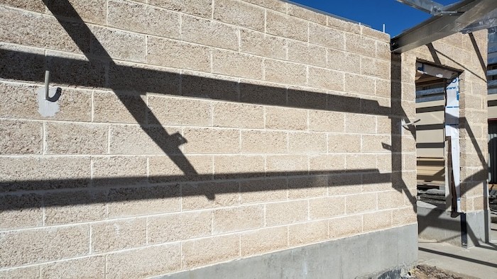 A photo outside showing the output of a wall made in hempcrete blocks