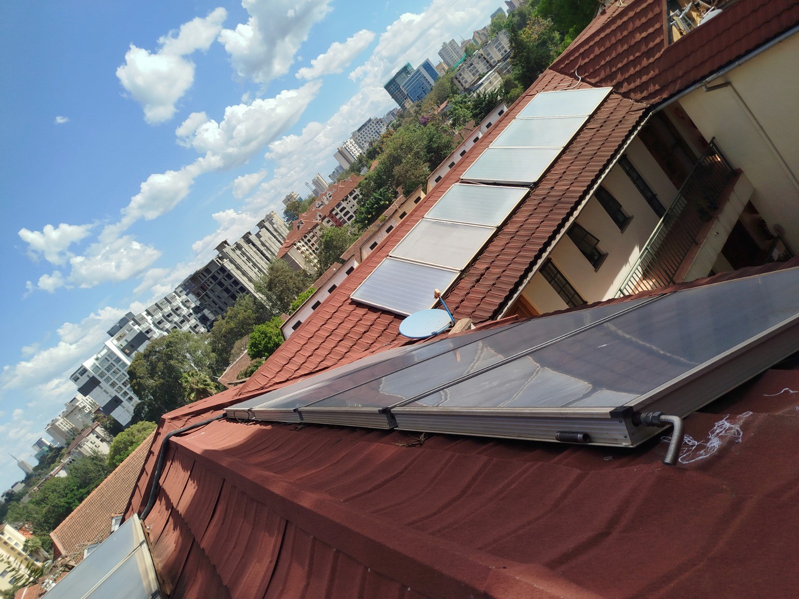 an aerial view of a building with solar panels on the roof