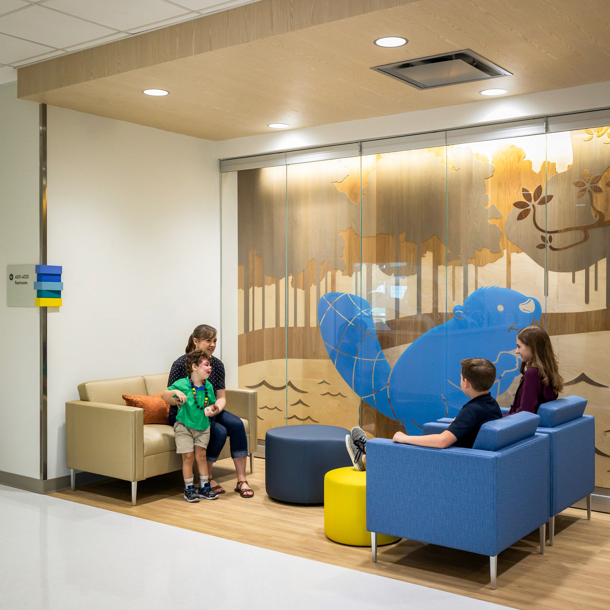 Family in waiting room with whimsical mural