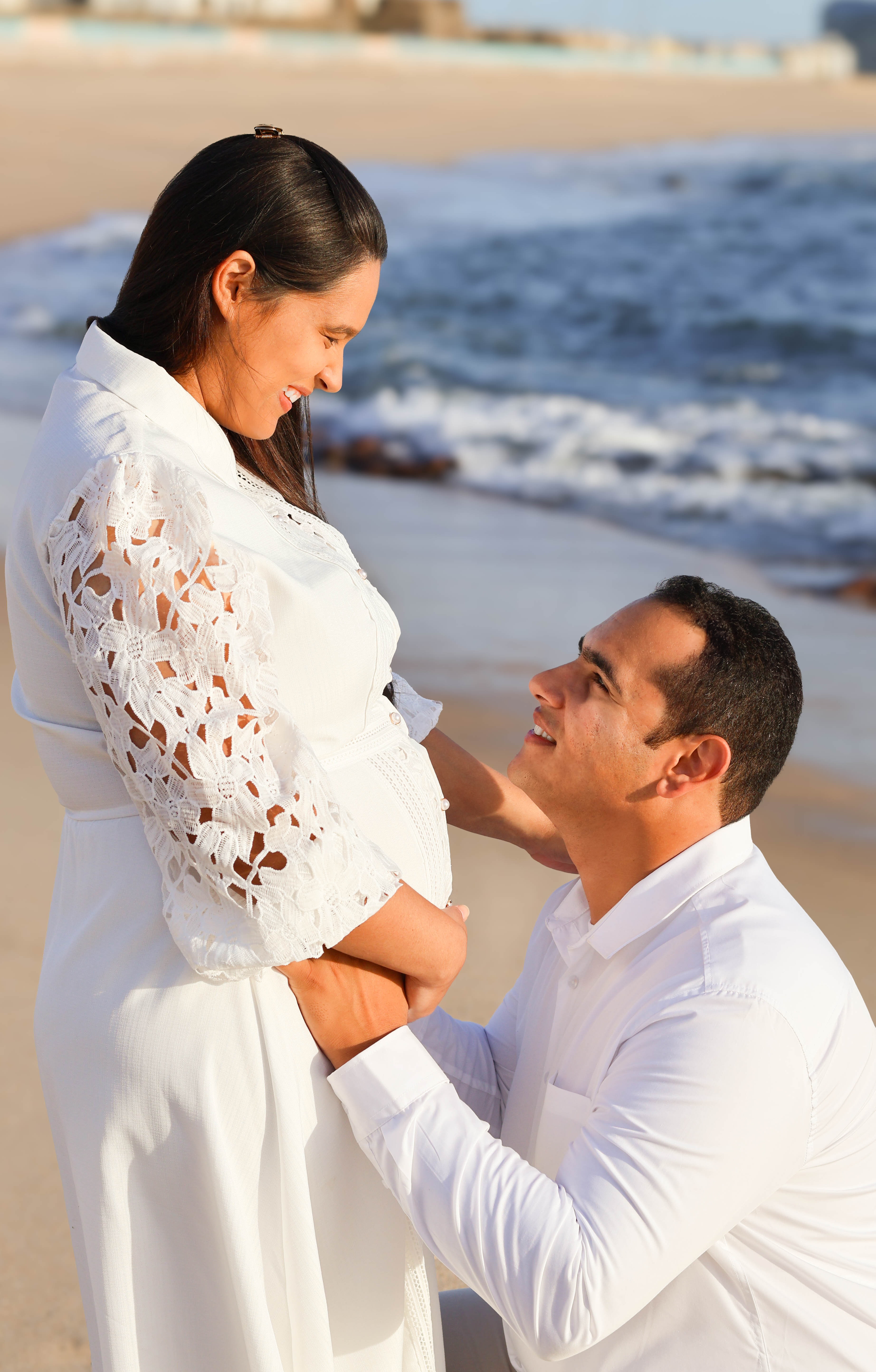 A bride in a lace wedding dress gently holds.