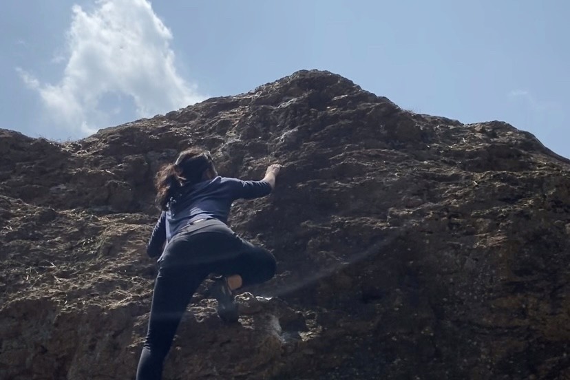 a woman holding a red flower