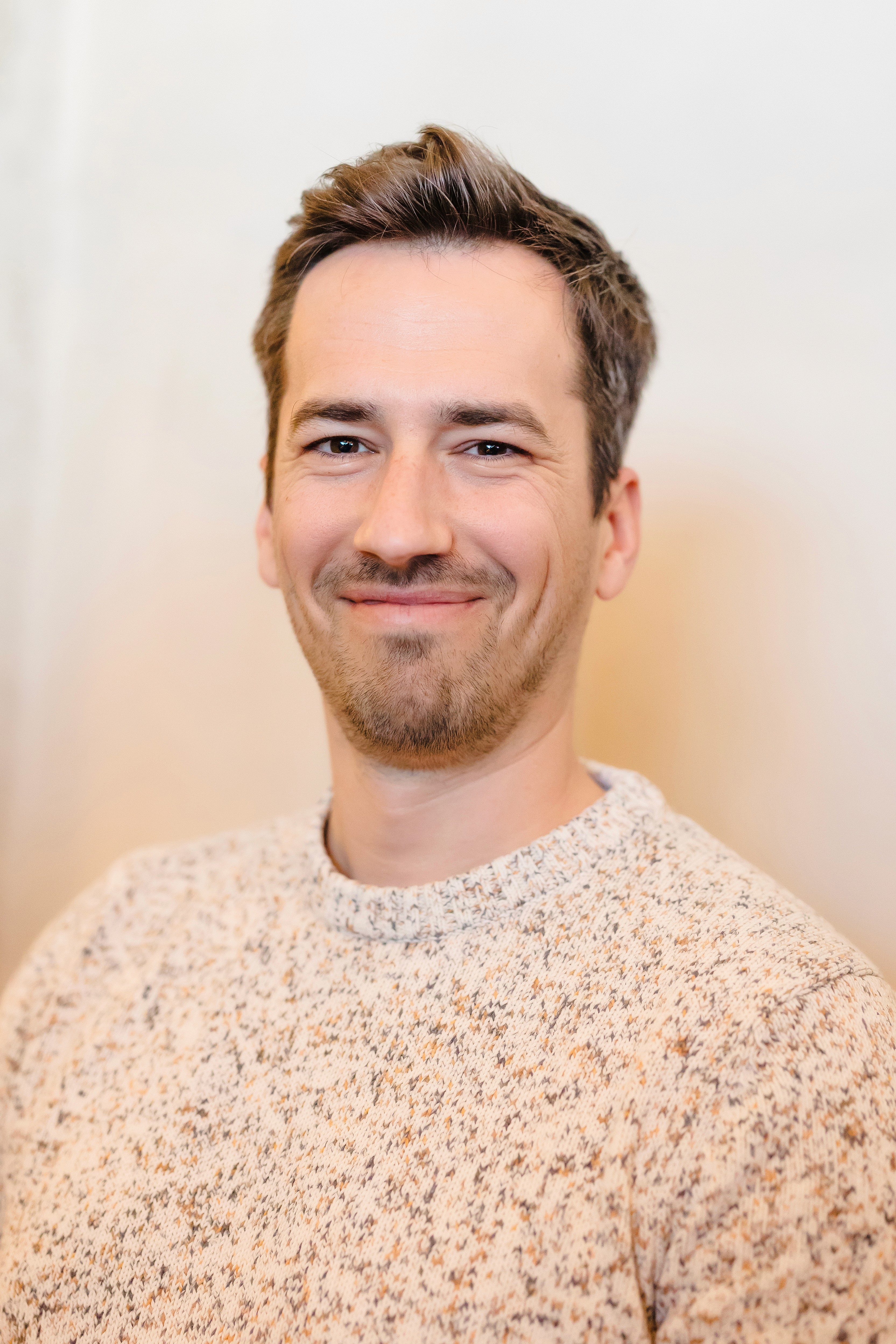 man in gray polo shirt smiling