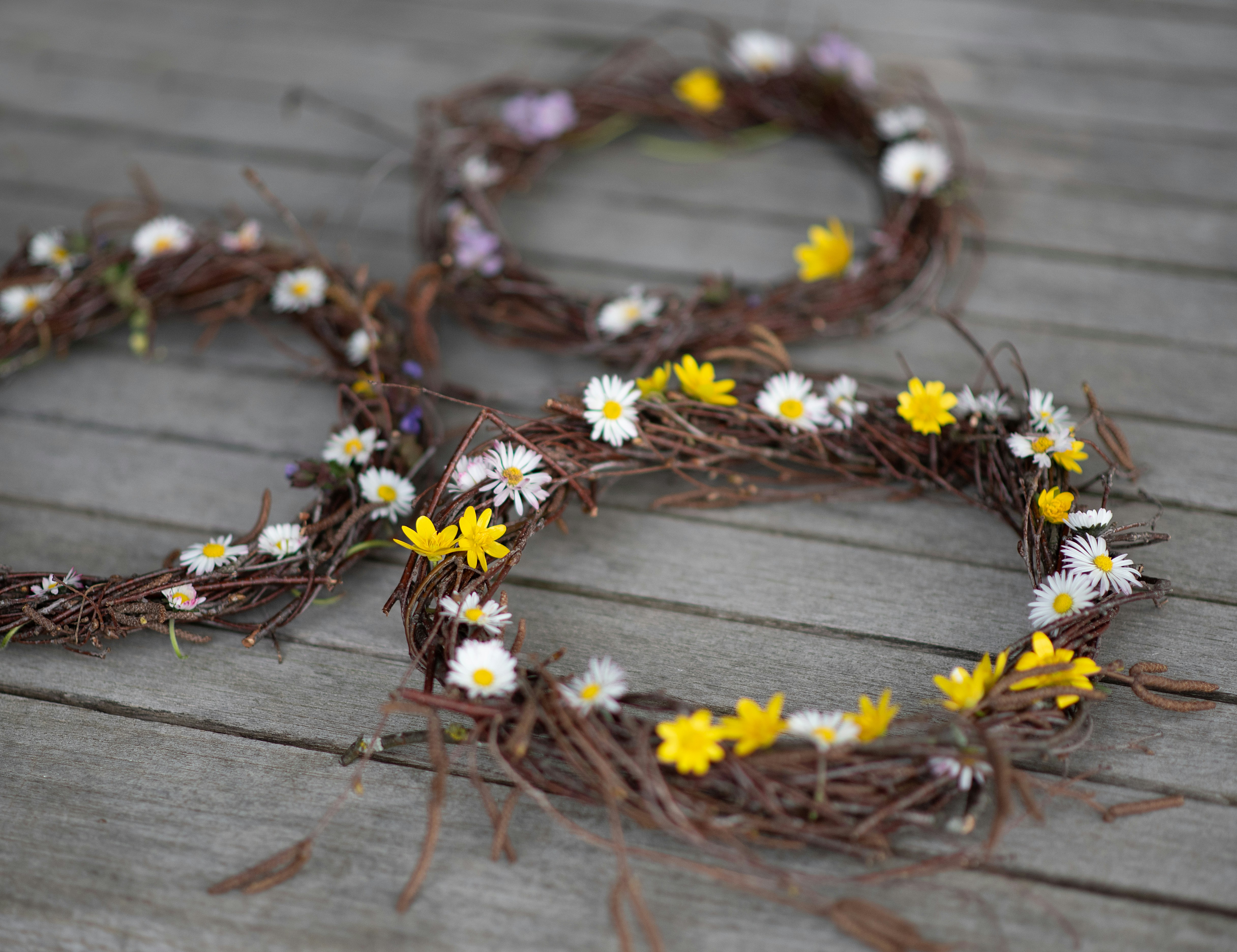 Wreaths adorned with wildflowers. Photo by Nadine Gem on Unsplash