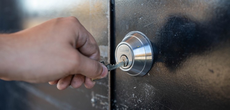 person opening high-security lock with a key