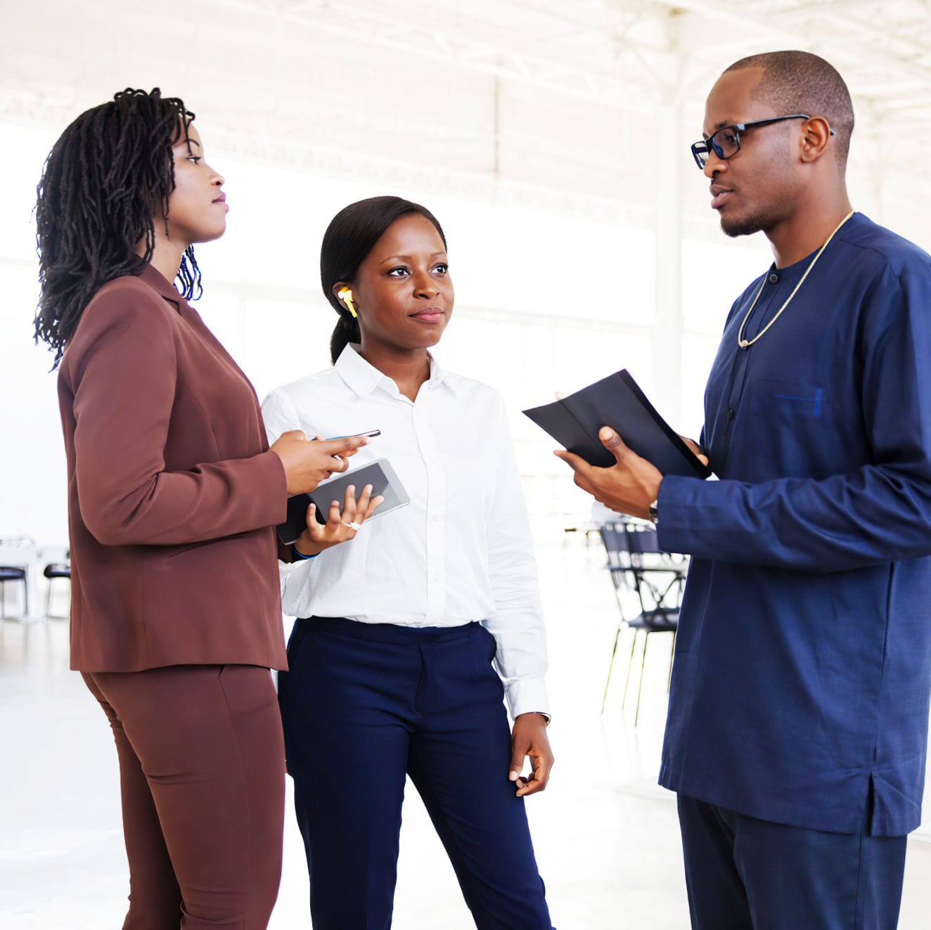 Aerial view of a winding road cutting through rocky terrain with patches of grass.