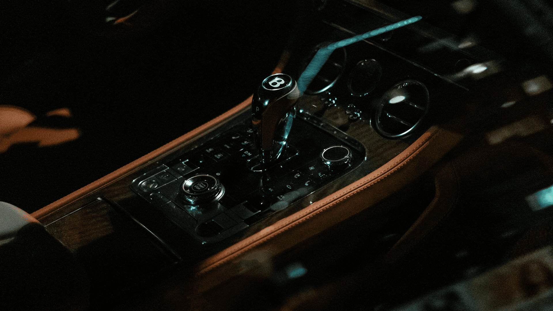 Person standing by a futuristic vehicle on a salt flat.