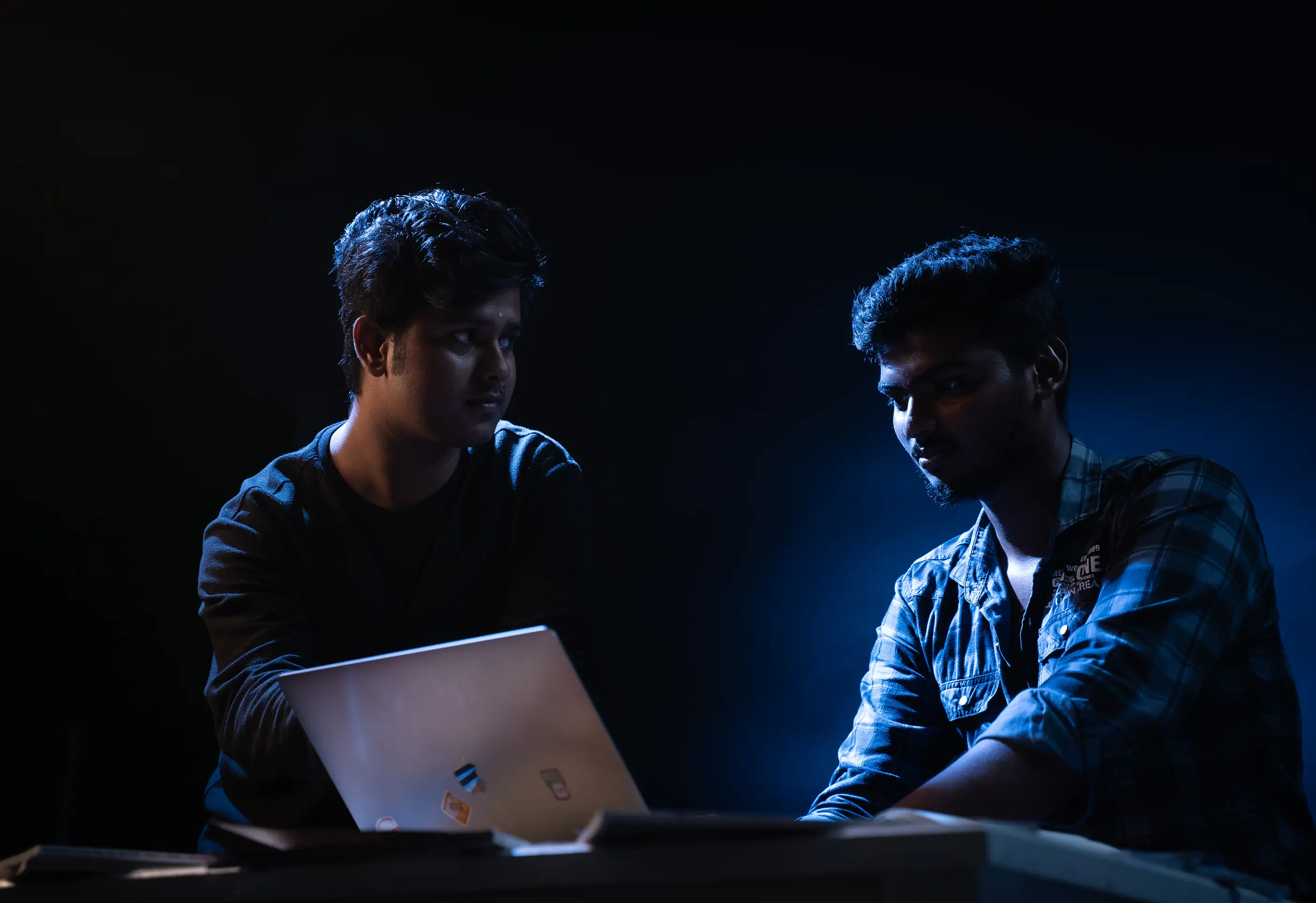 Two creators from a content production company brainstorming and developing concepts in a studio