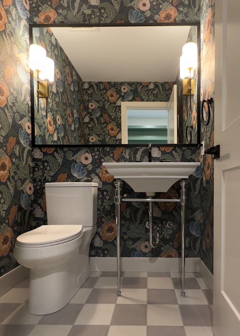 Image of Luxury bathroom interior design by KHD Homes featuring a stylish sink, toilet, and floral wallpaper.