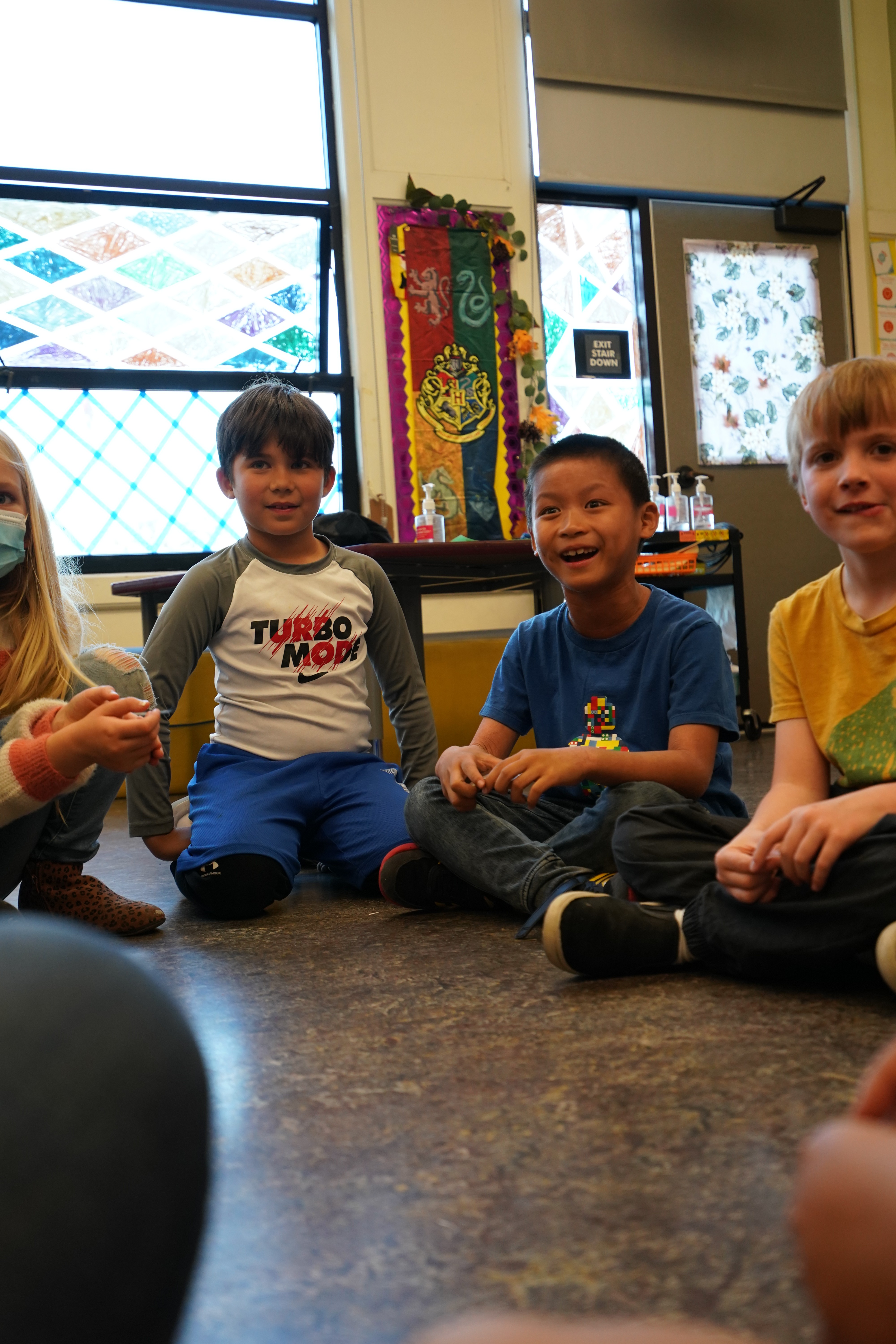 Children sitting in a circle during a HOKALI aftercare activity, building social skills and positive connections.