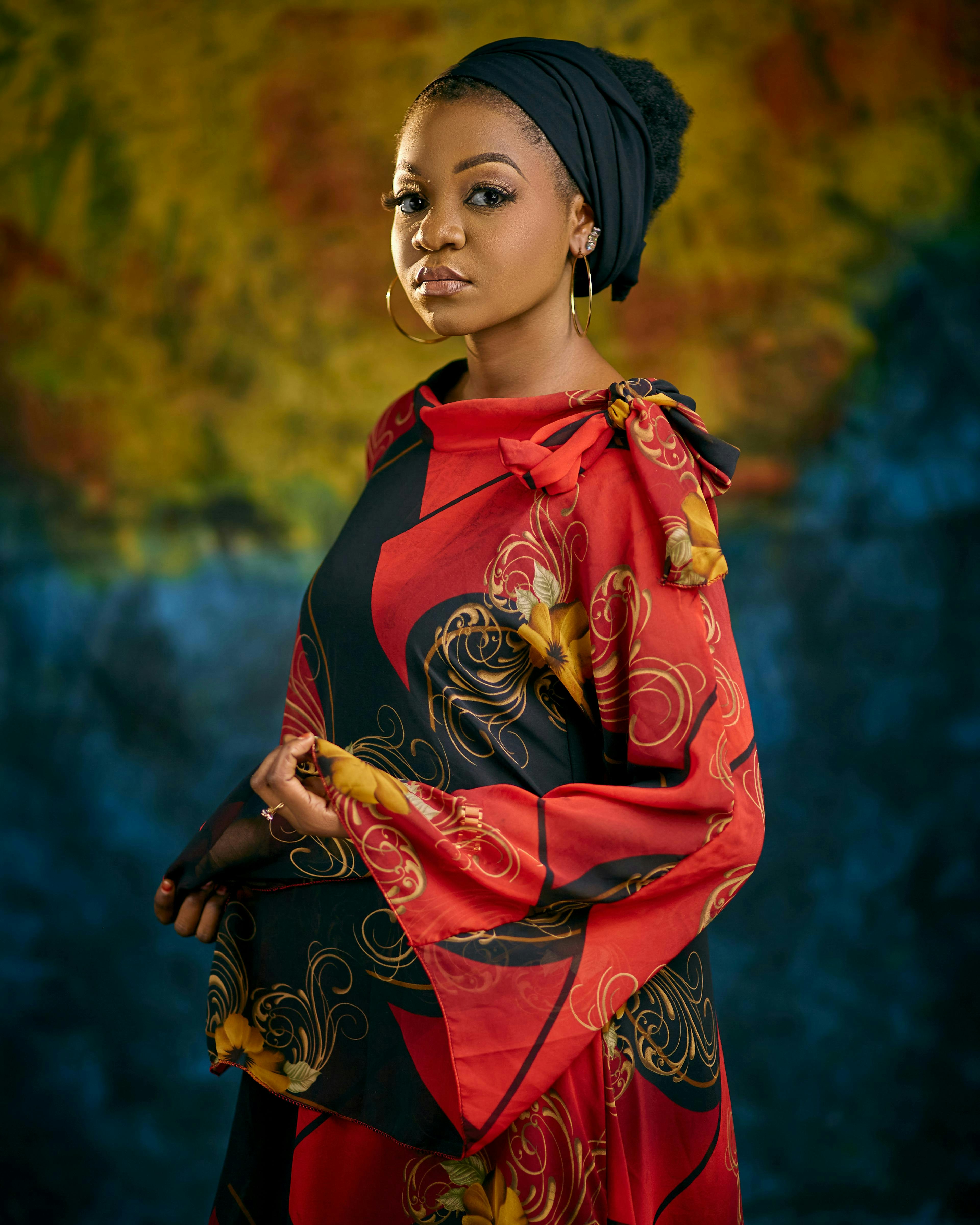 A woman poses in colorful clothing.