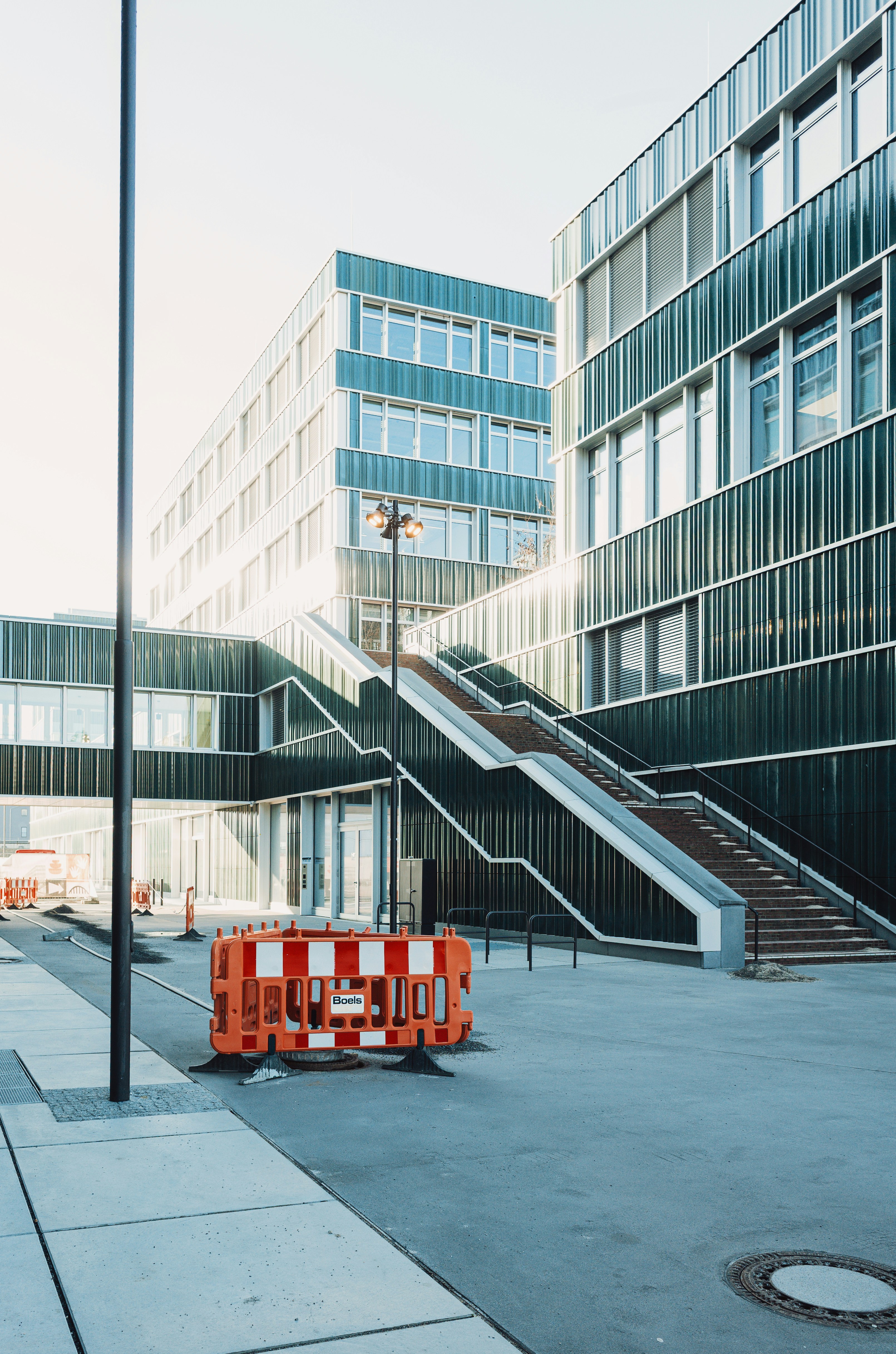 Modern office buildings with outdoor staircase and barrier.