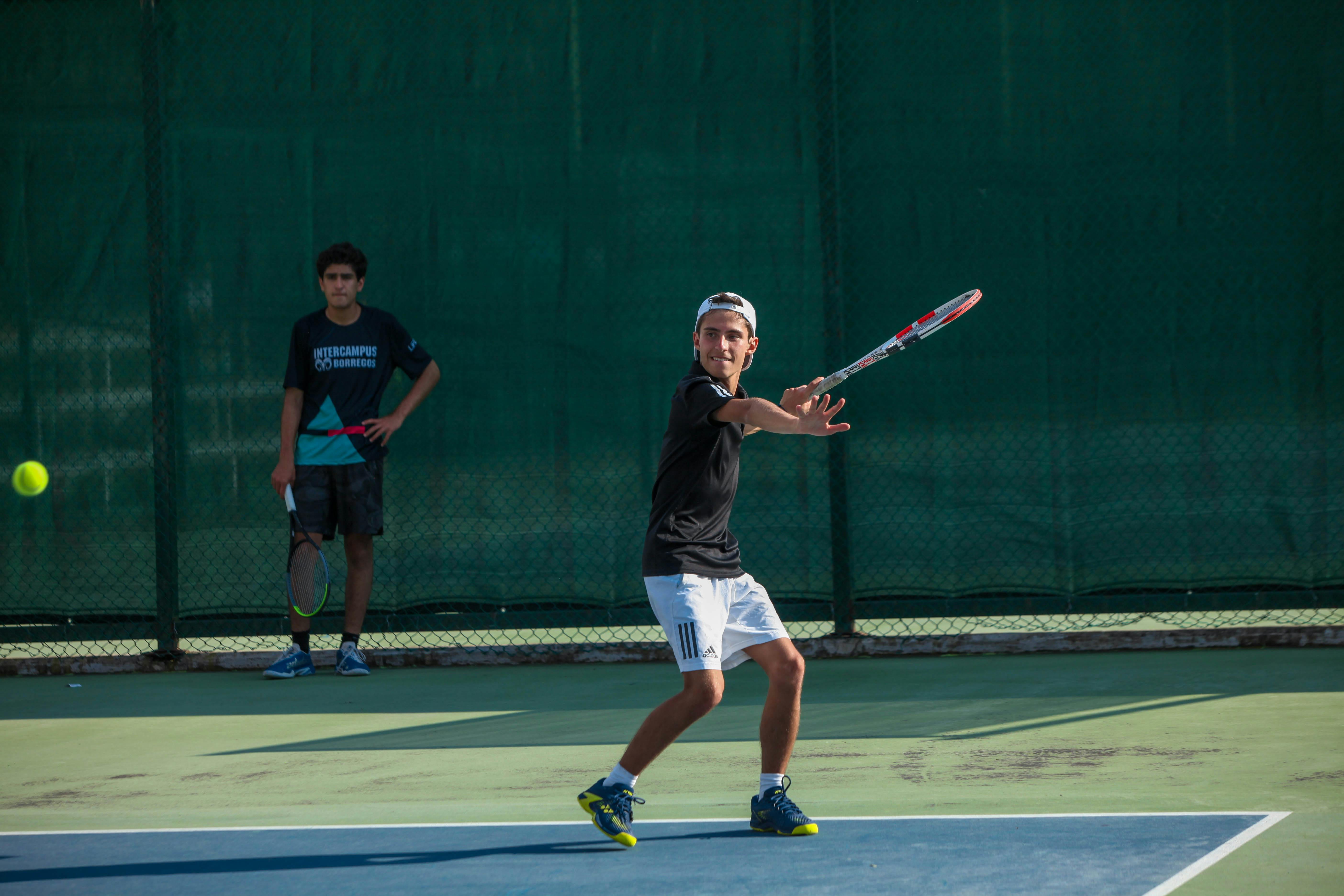 A kid playing tennis