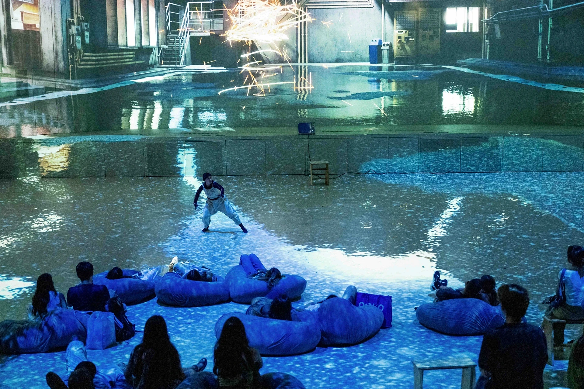 Performance with sparks and audience on beanbags.