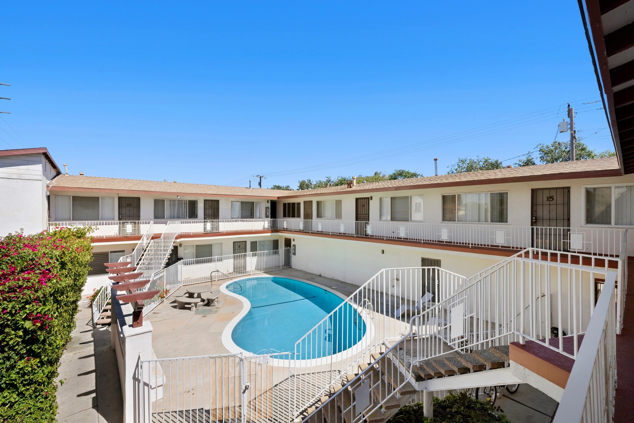 Pool area with lounge seating and stair access within courtyard at 11178 Culver Blvd.