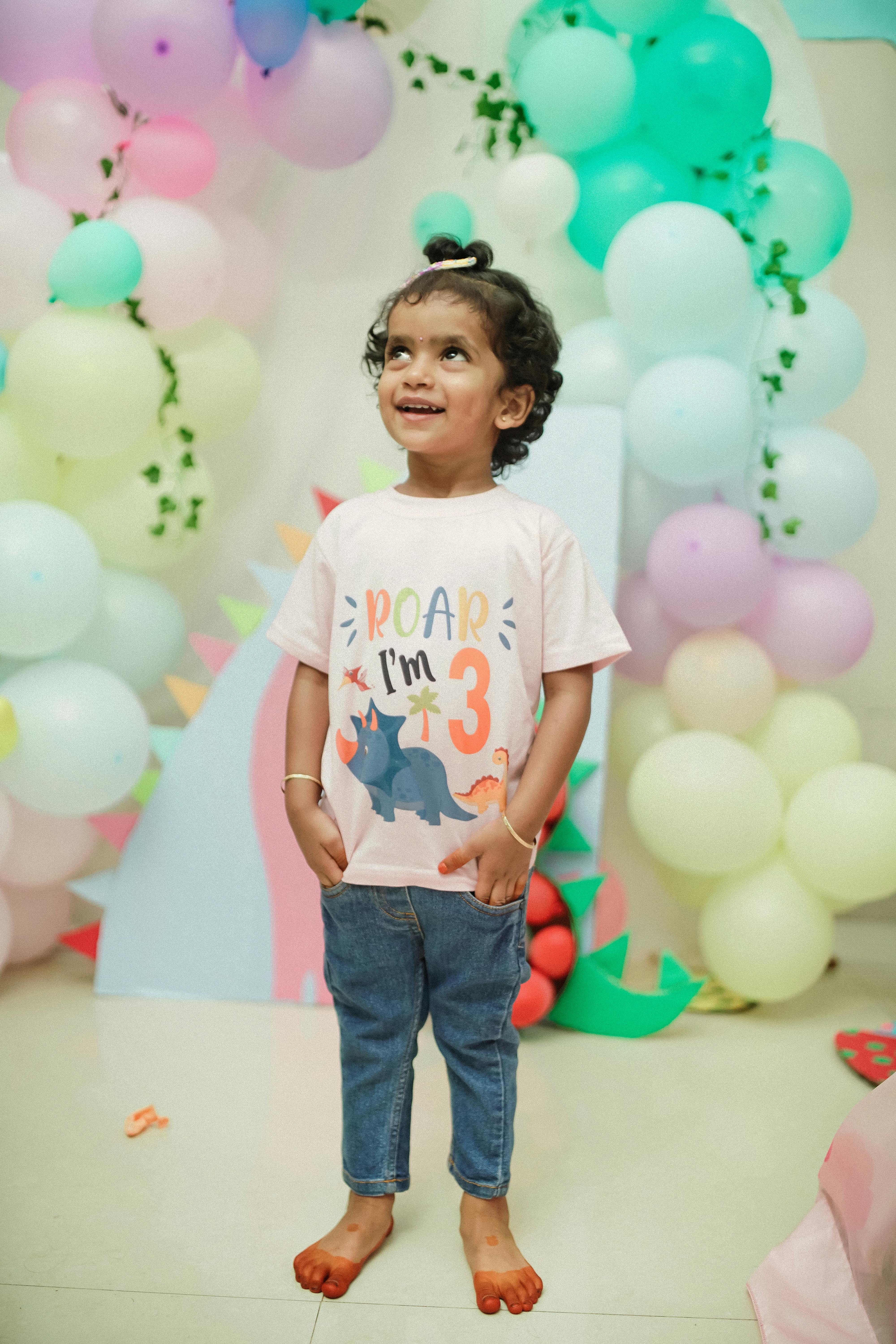 adorable-child-at-a-dinosaur-themed-3rd-birthday-party-with-colorful-balloons-an - suresh-photography (pexels)