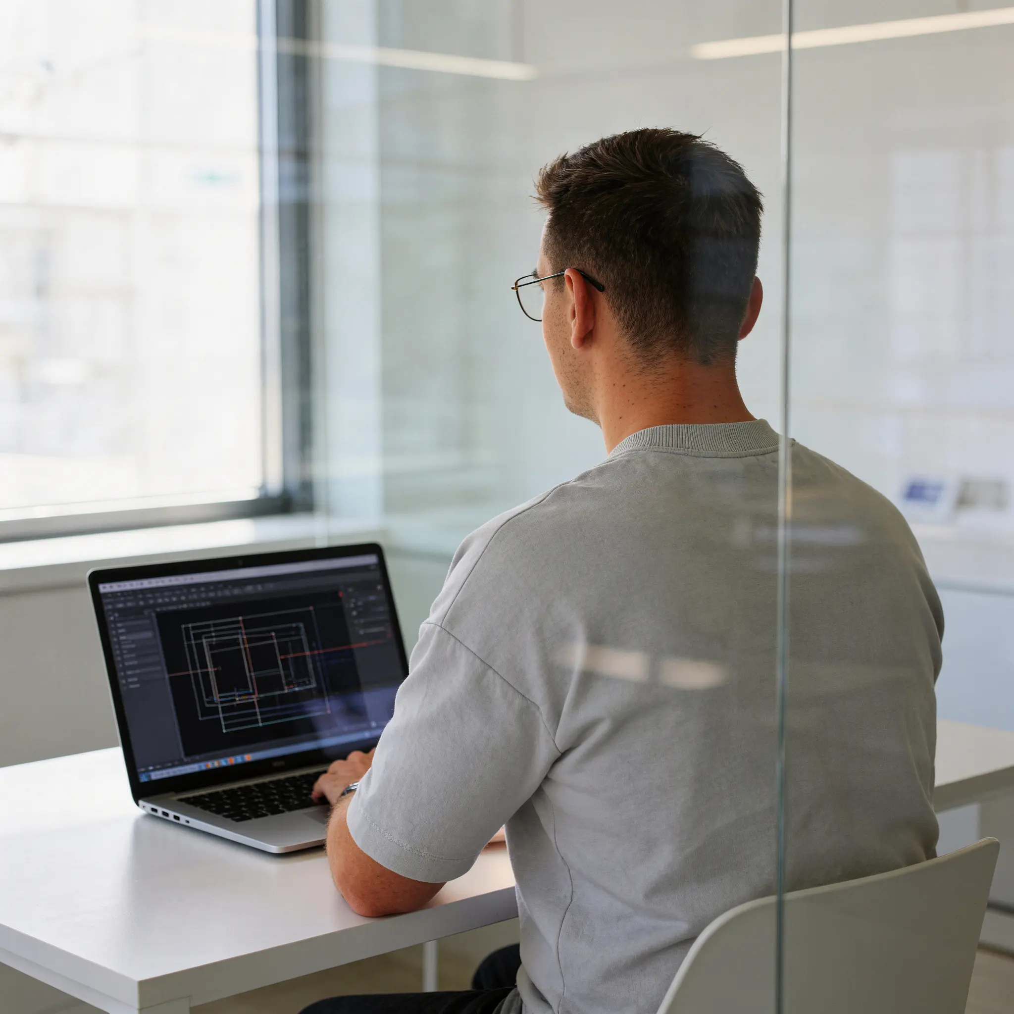 Smiling young Asian woman with long black hair, wearing a brown turtleneck against a neutral gray background. Warm and approachable vibe.