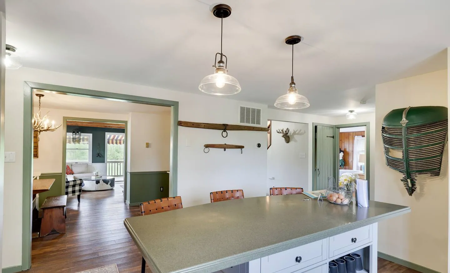 Kitchen island with pendant lights and view into the living room at Rocking Horse Acres