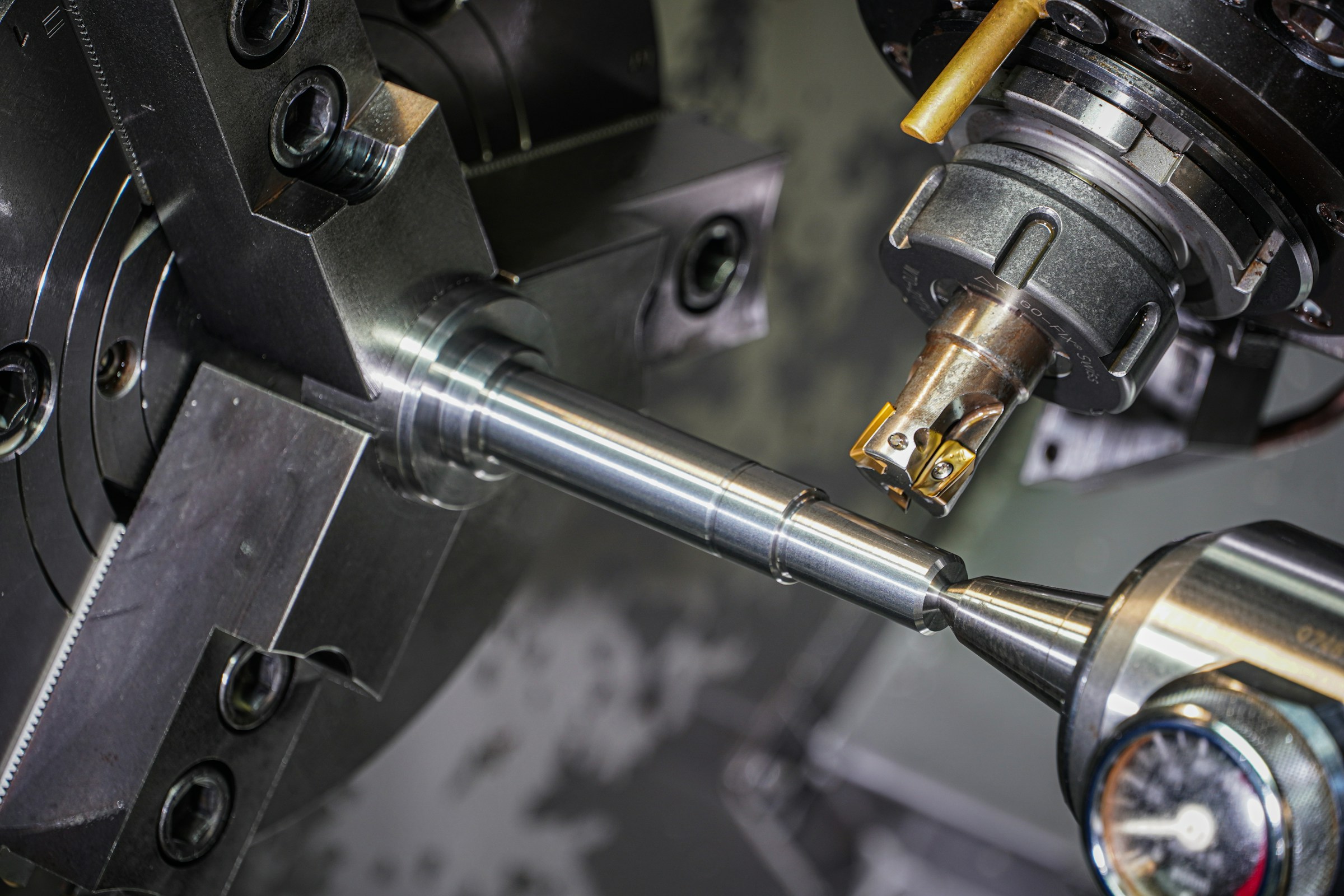 Metal bar being machined on a lathe