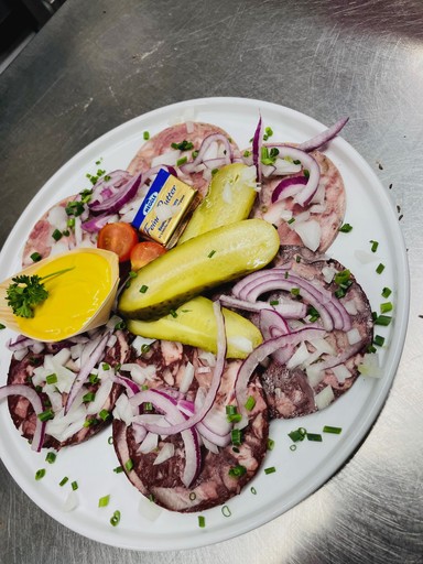 Close-up of a dark green leaf showing its textured surface and central vein against a muted background.