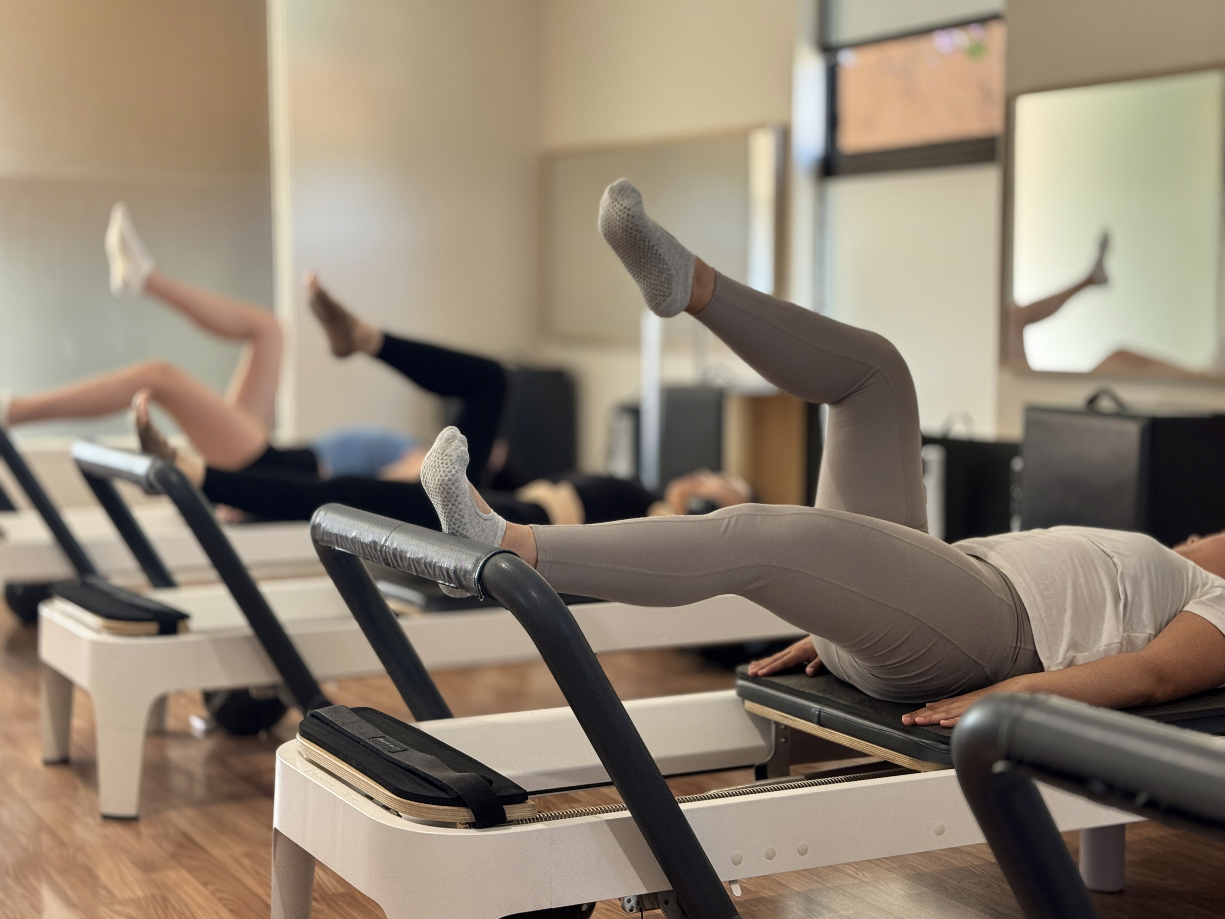 a woman is doing a piyoma exercise in a gym