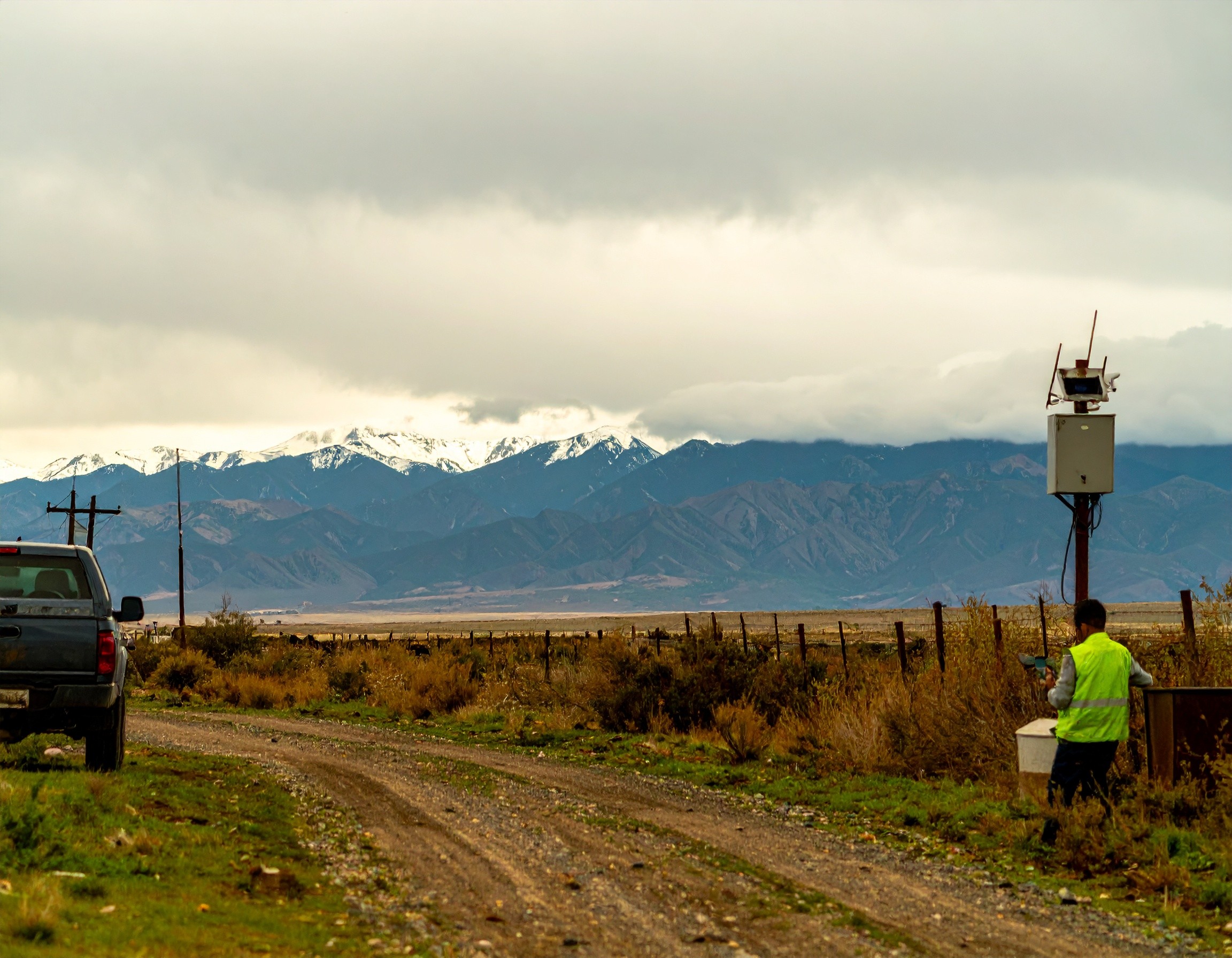 sprawling field, technician below networking box