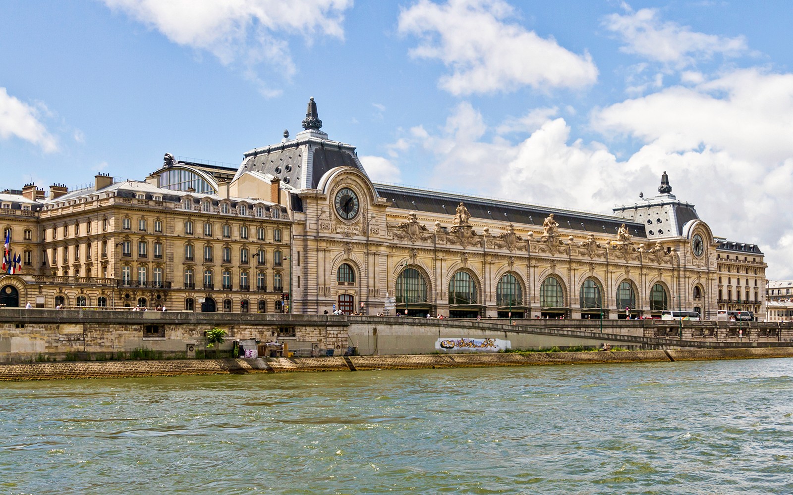 Orsay Museum exterior along the Seine River in Paris, offering fast-track tickets and exhibitions.