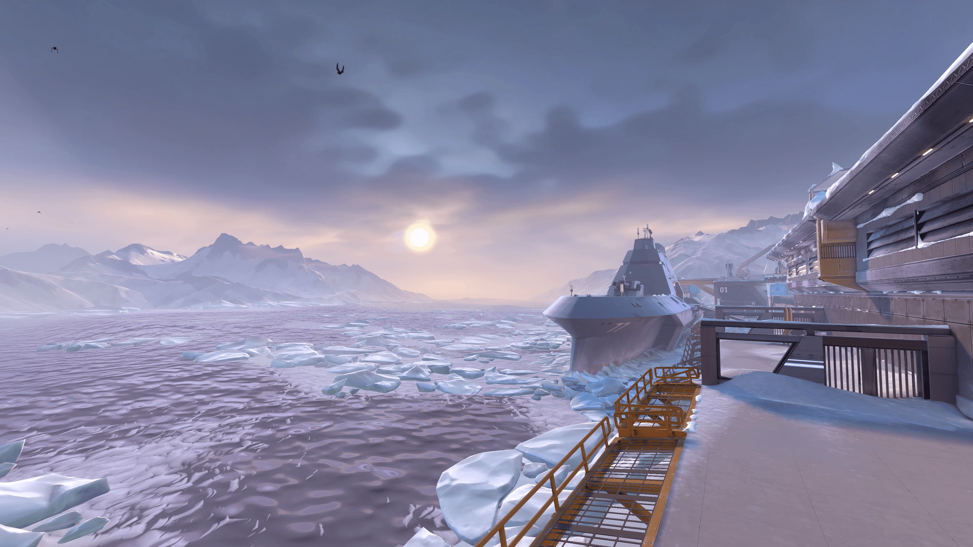 A man with long hair is working on a computer.