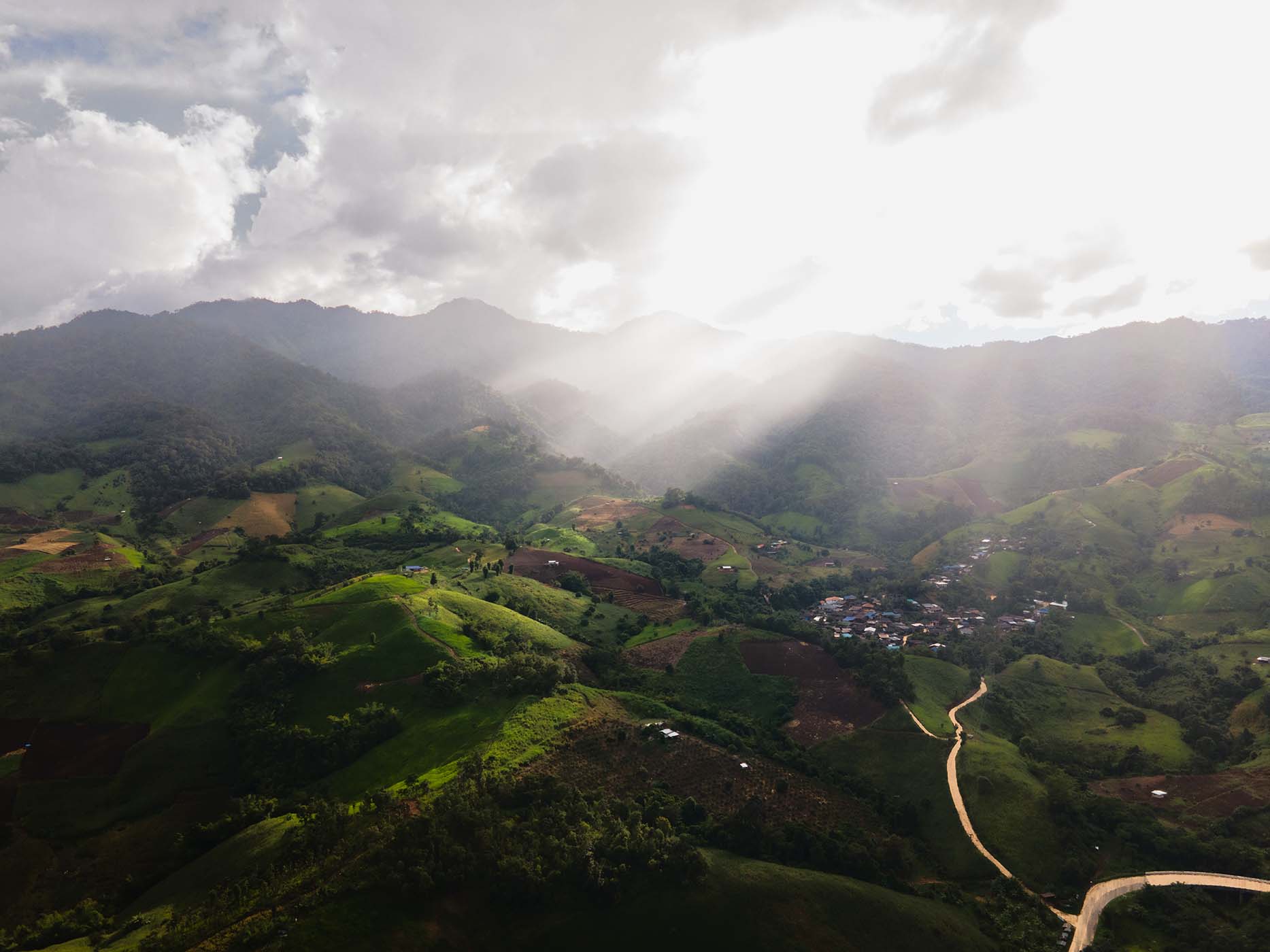 Drone landscape of mountains with sunlight rays in Chiang Mai, Thailand.
