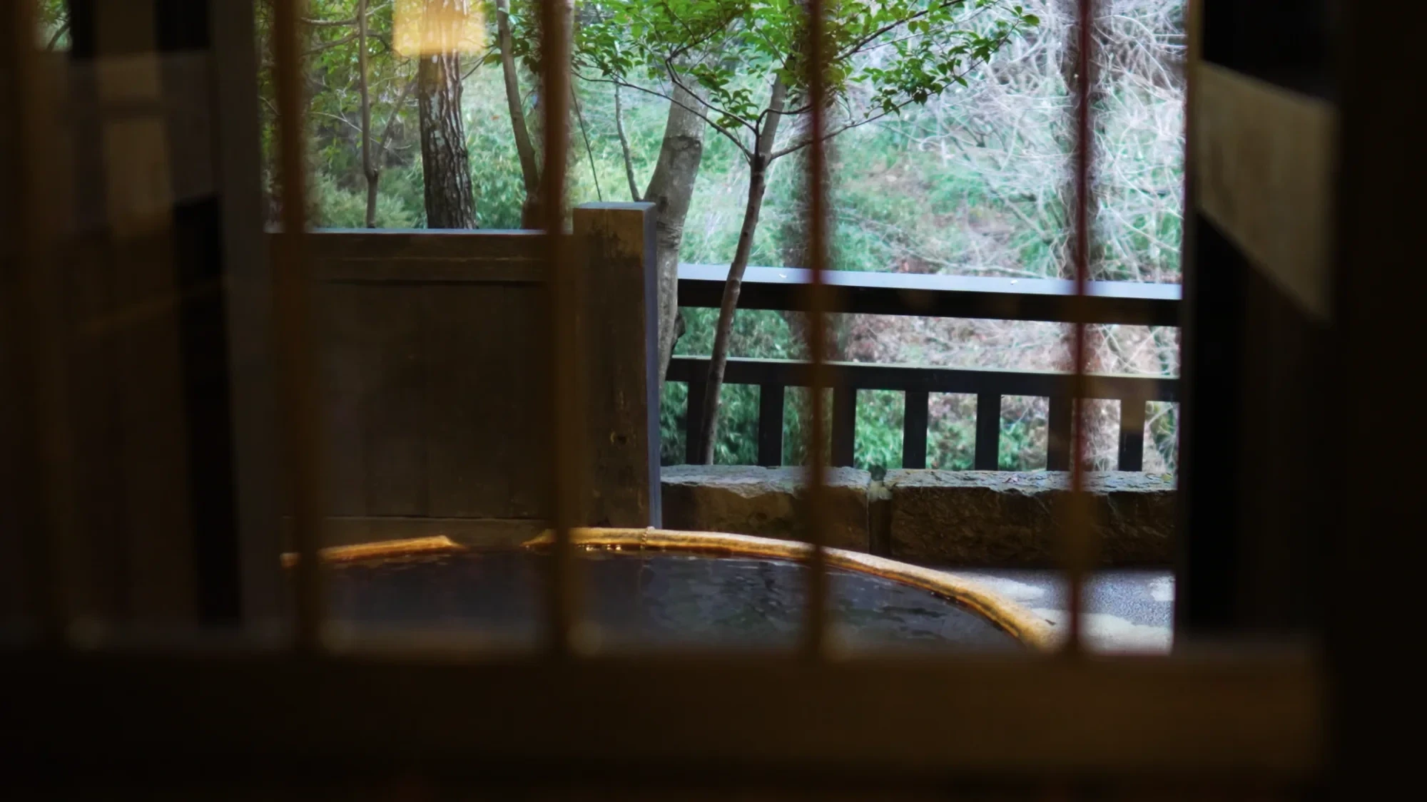 A round bathing tub at Kurokawa Onsen framed by a window opening
