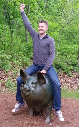 Holland riding the mythical, bronze pig in the forest.