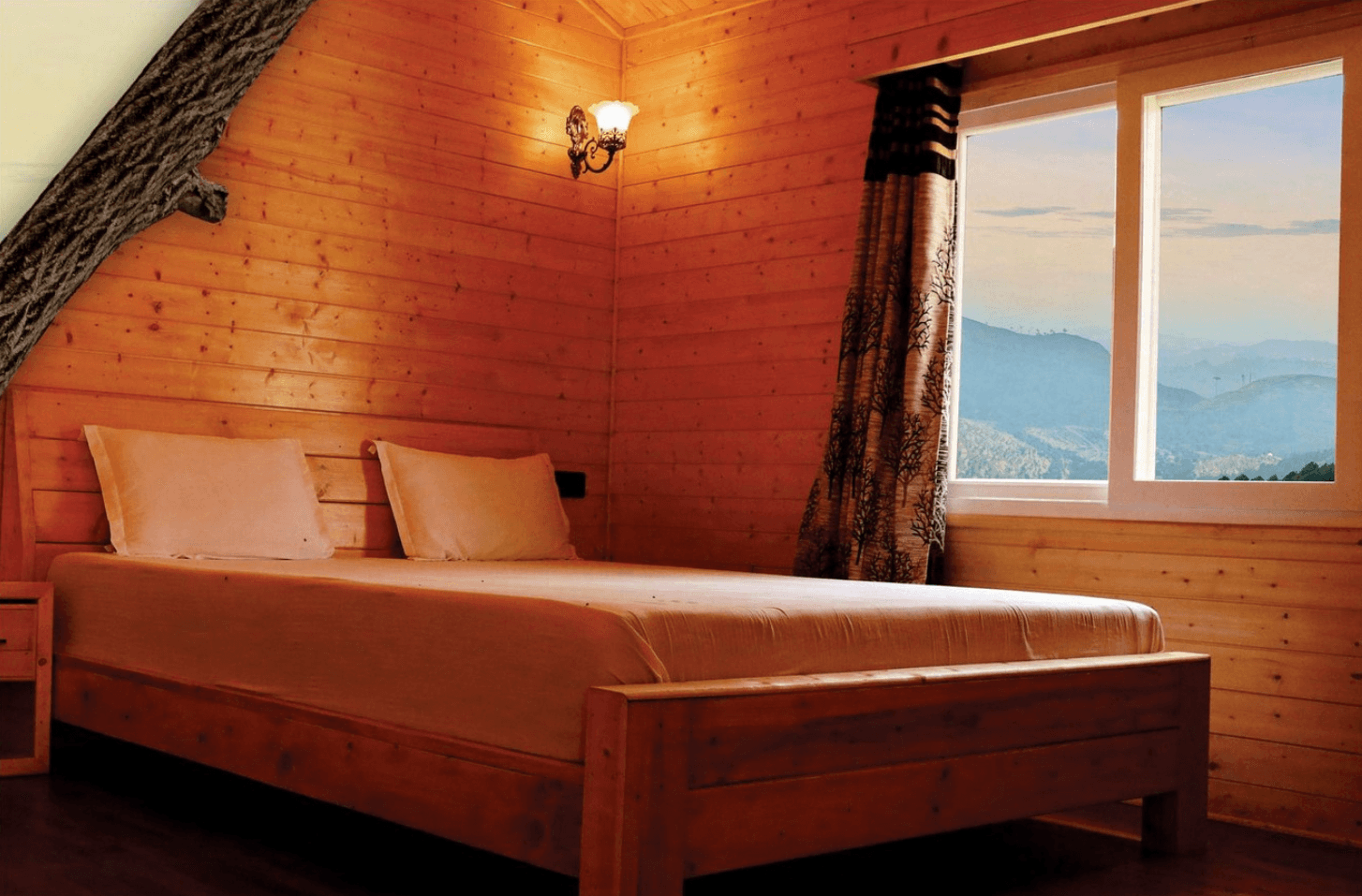 <img src="bedroom-view.jpg" alt="Bed in a bedroom with a window overlooking mountains and blue sky.">