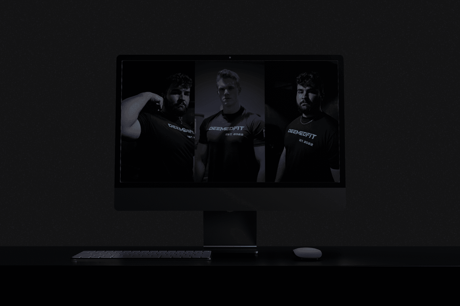 a dark room with a large monitor showcasing multiple photos of men in black shirts