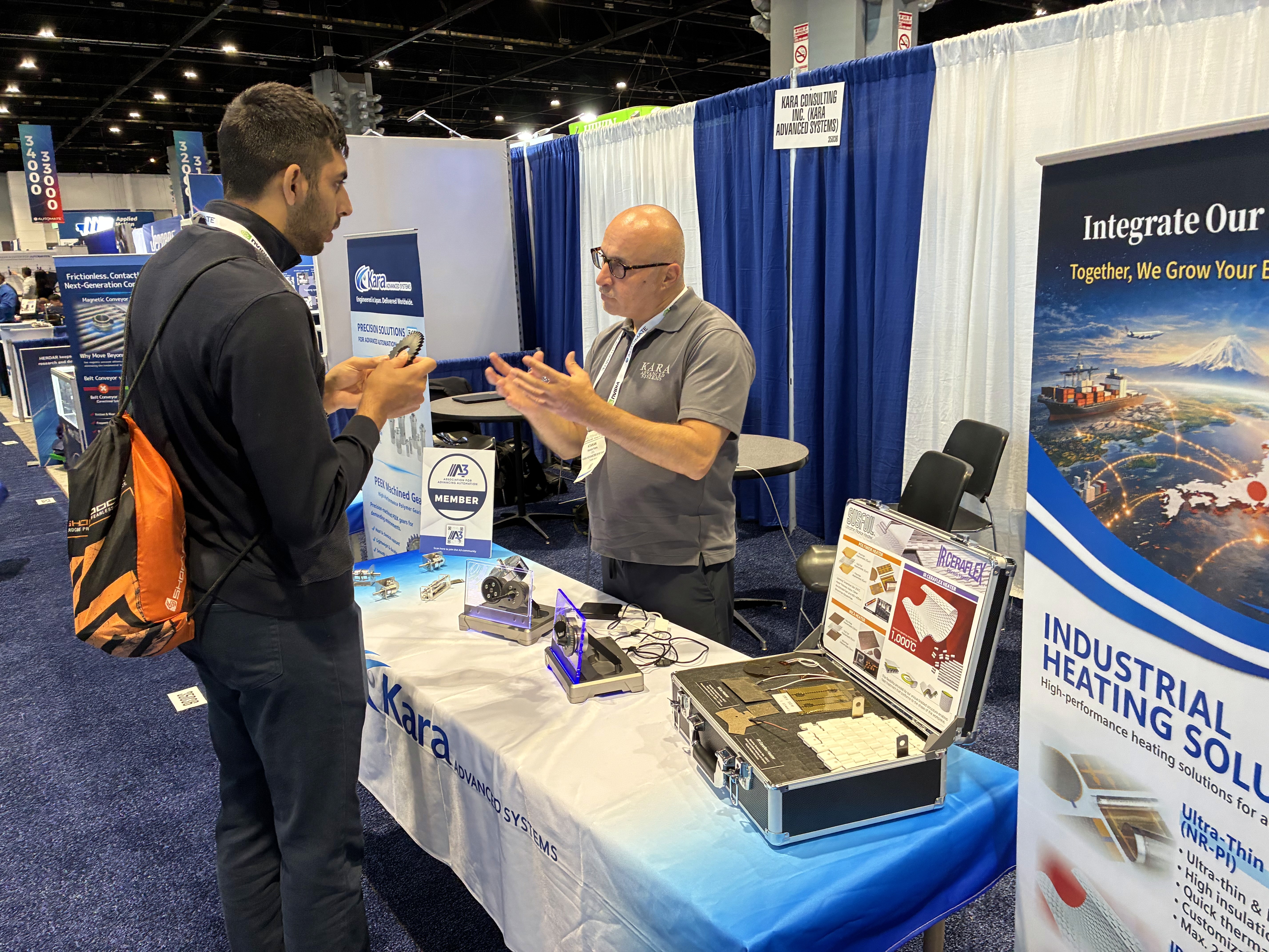 Kara Advanced Systems presenting industrial technology to a customer at an international manufacturing exhibition.
