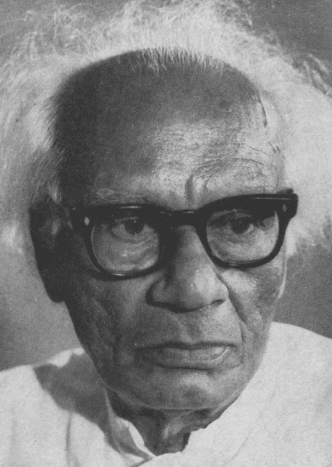 A man playing a drum in front of a group of people