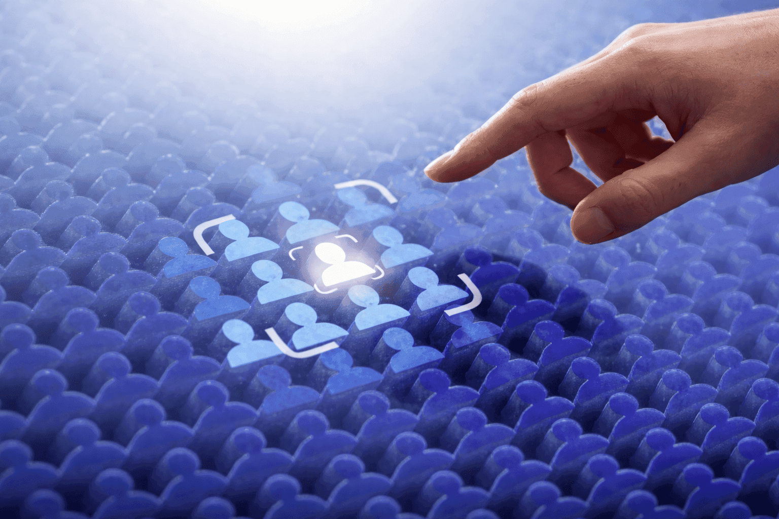 Hand selecting a highlighted user icon among many, illustrating customer segmentation and personalization in e-commerce
