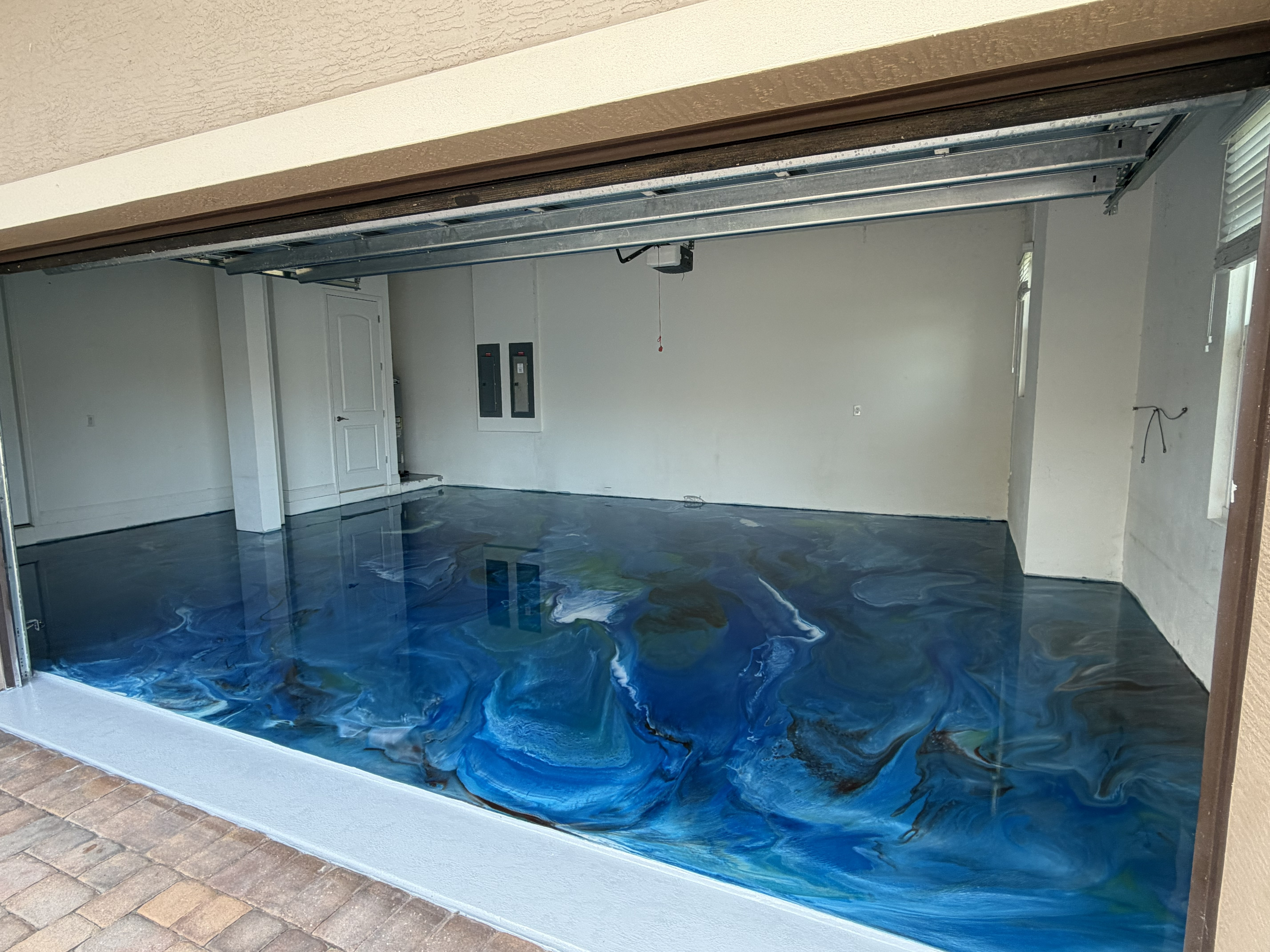 Custom blue metallic garage floor angle view