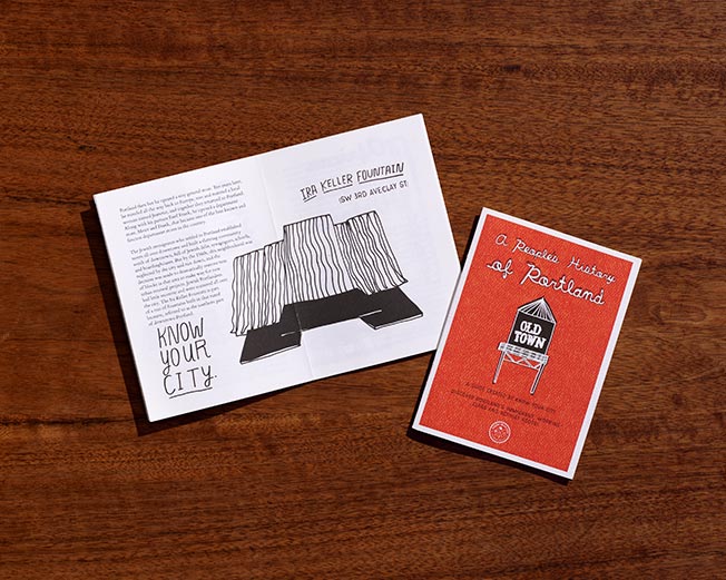 Open zine spread beside a red illustrated cover
