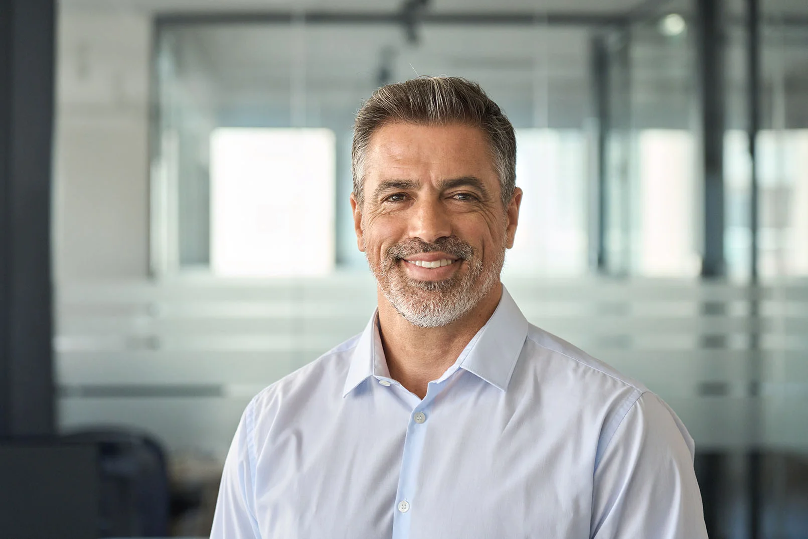 Smiling patient featured in a modern portrait representing implant-supported denture treatment and restored confidence.