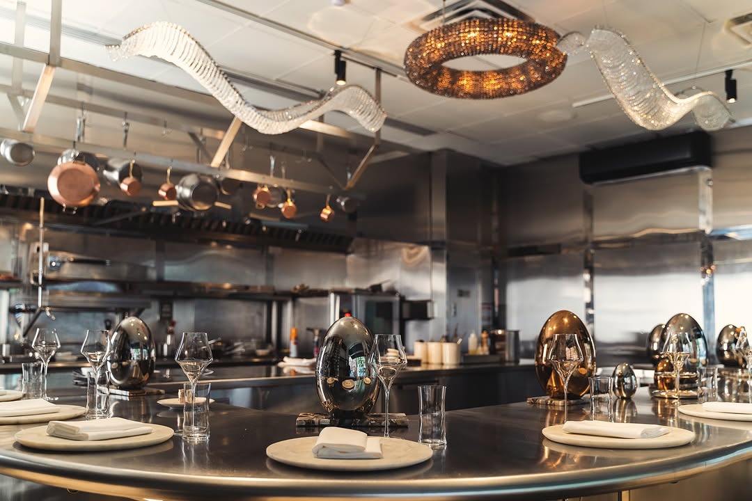 A glimpse into Maison Sun's refined kitchen, showcasing copper cookware and a minimalist, state-of-the-art setup used to create their 14-seat tasting menu.