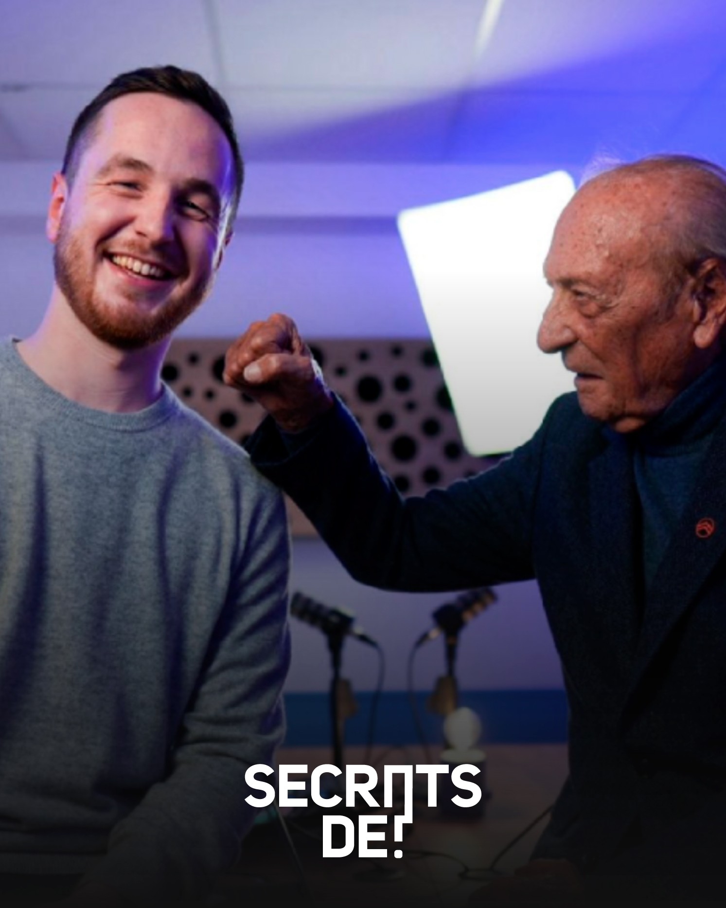 Modern home office setup with a monitor, ergonomic chair, keyboard, and indoor plants near a window with blinds.