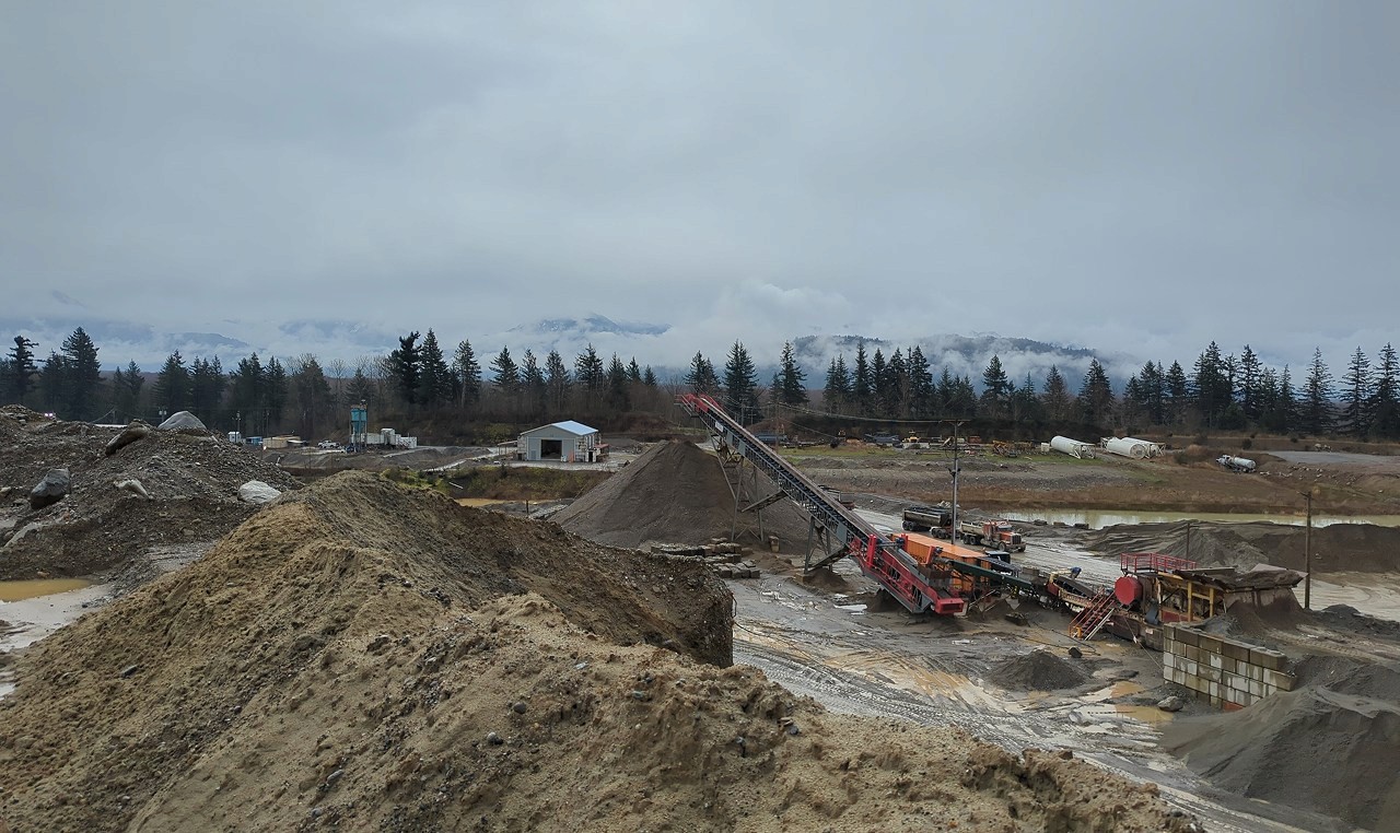Aggregate processing facility with stockpiles and conveyor systems at Woodbrook pit in Fraser Valley